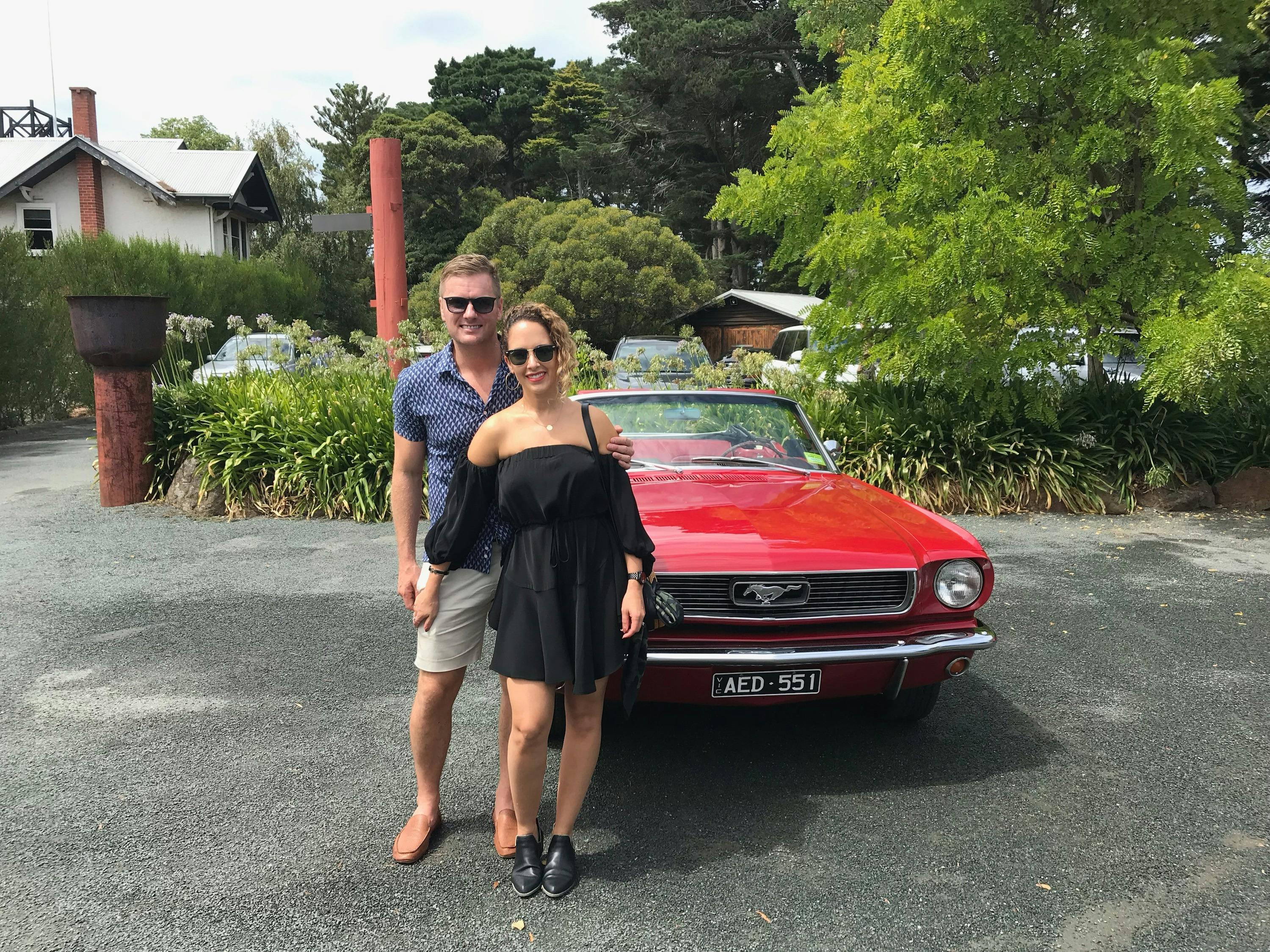 Young couple on a Bellarine winery tour photo taken with Vintage Mustang convertible at Oakdene .