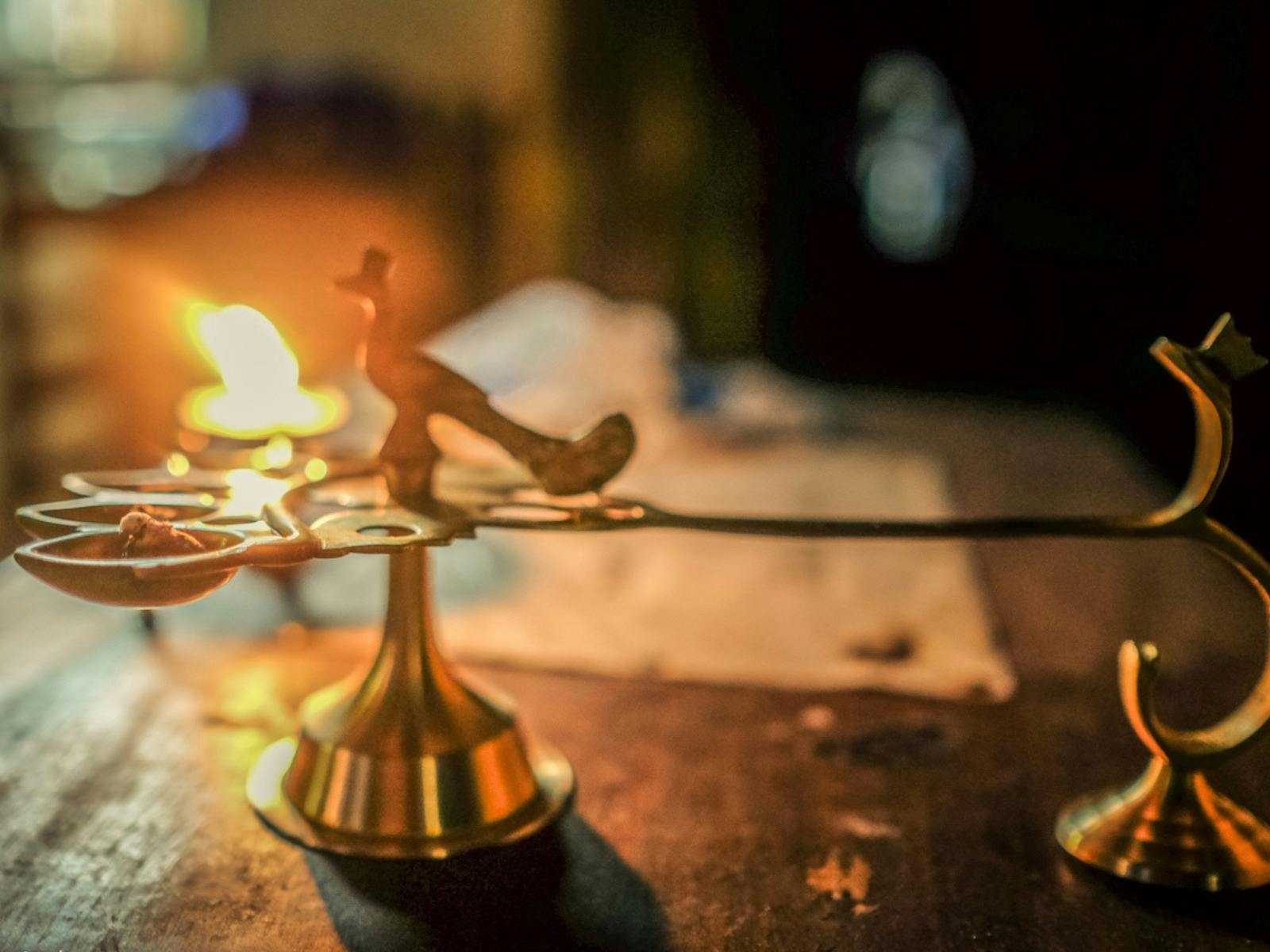 A temple oil light burning, inviting spiritual seekers