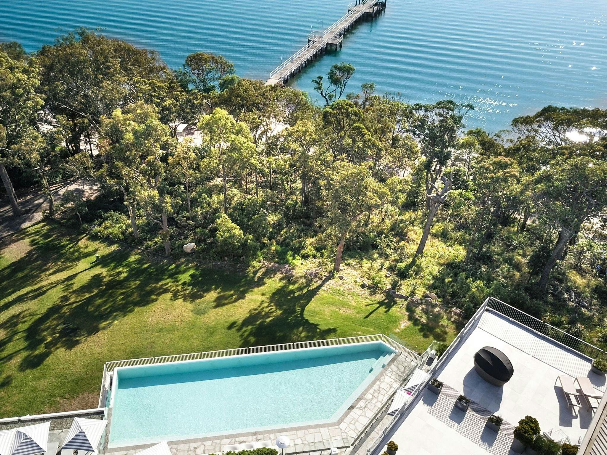 Drone shot showing hotel pool and, gardens and ocean beyond