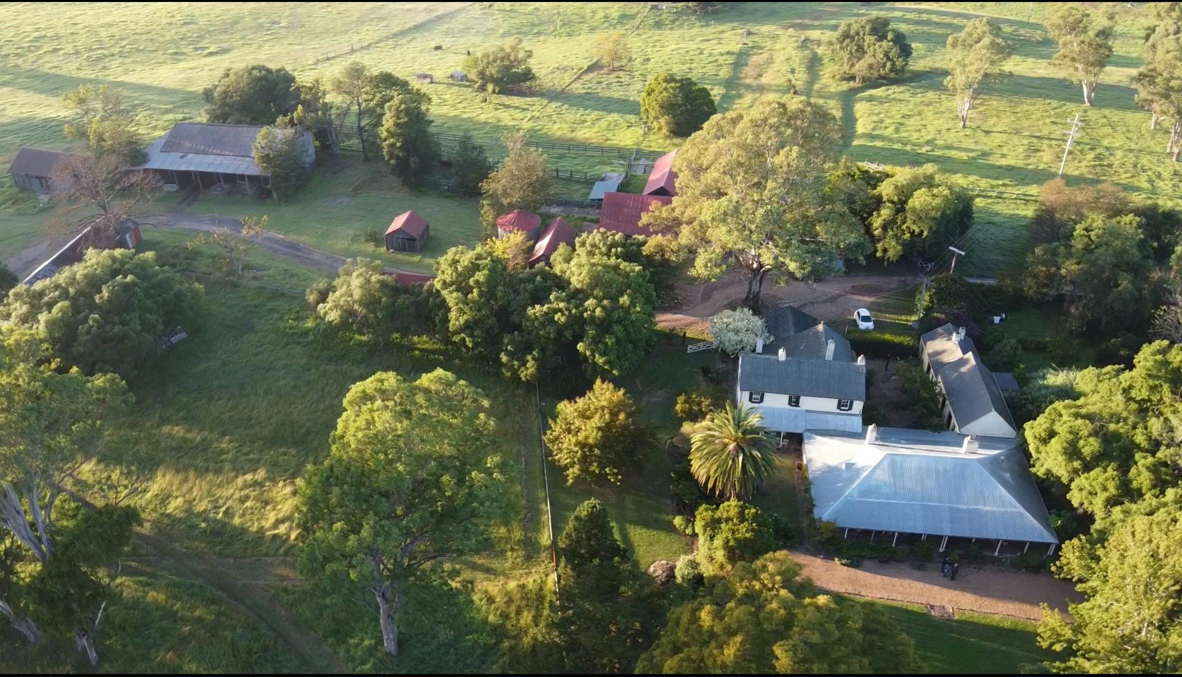 Landscape overhead of the house from the air with gardens