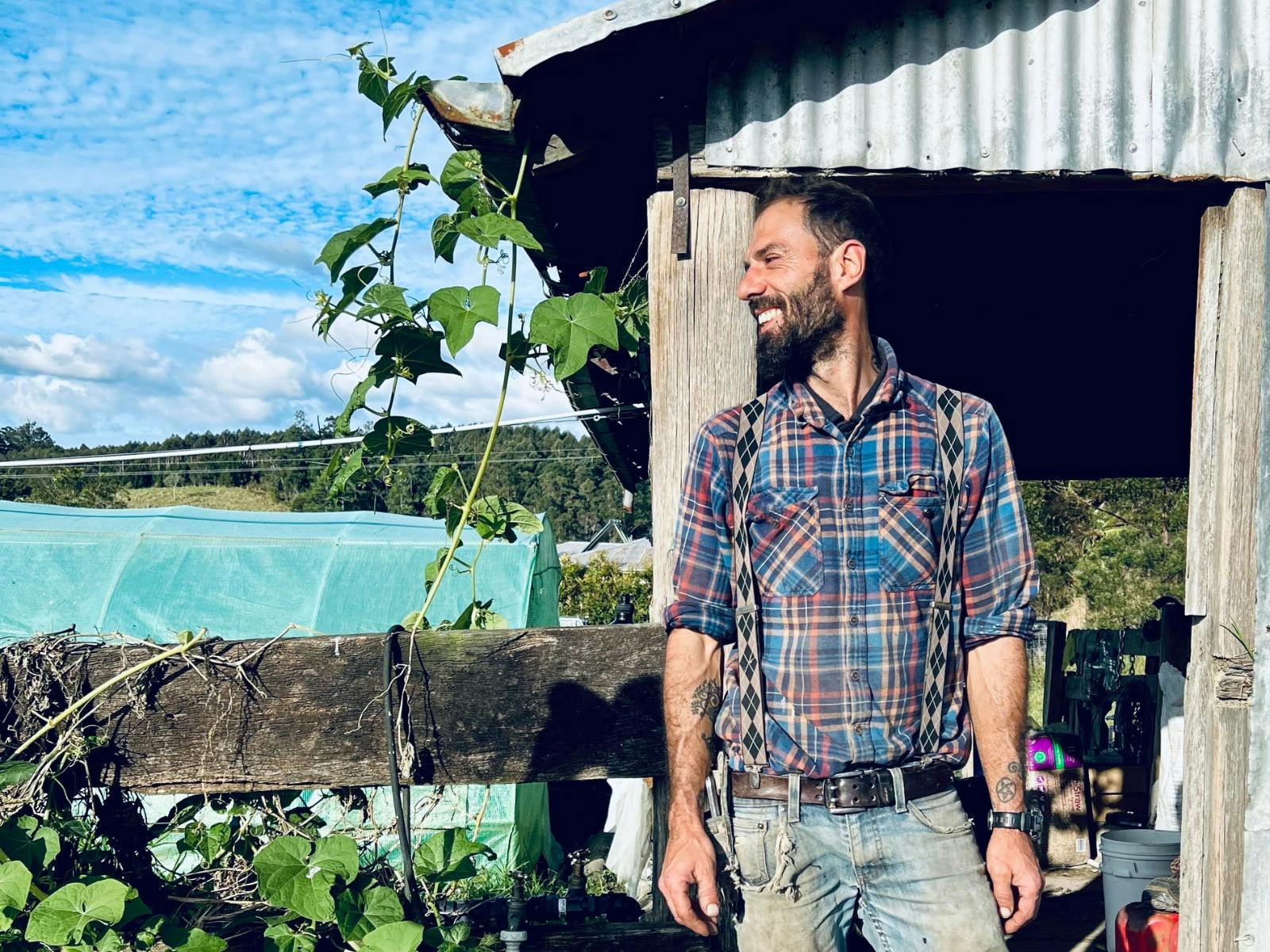 Farmer Luigi smiling in front of sheds