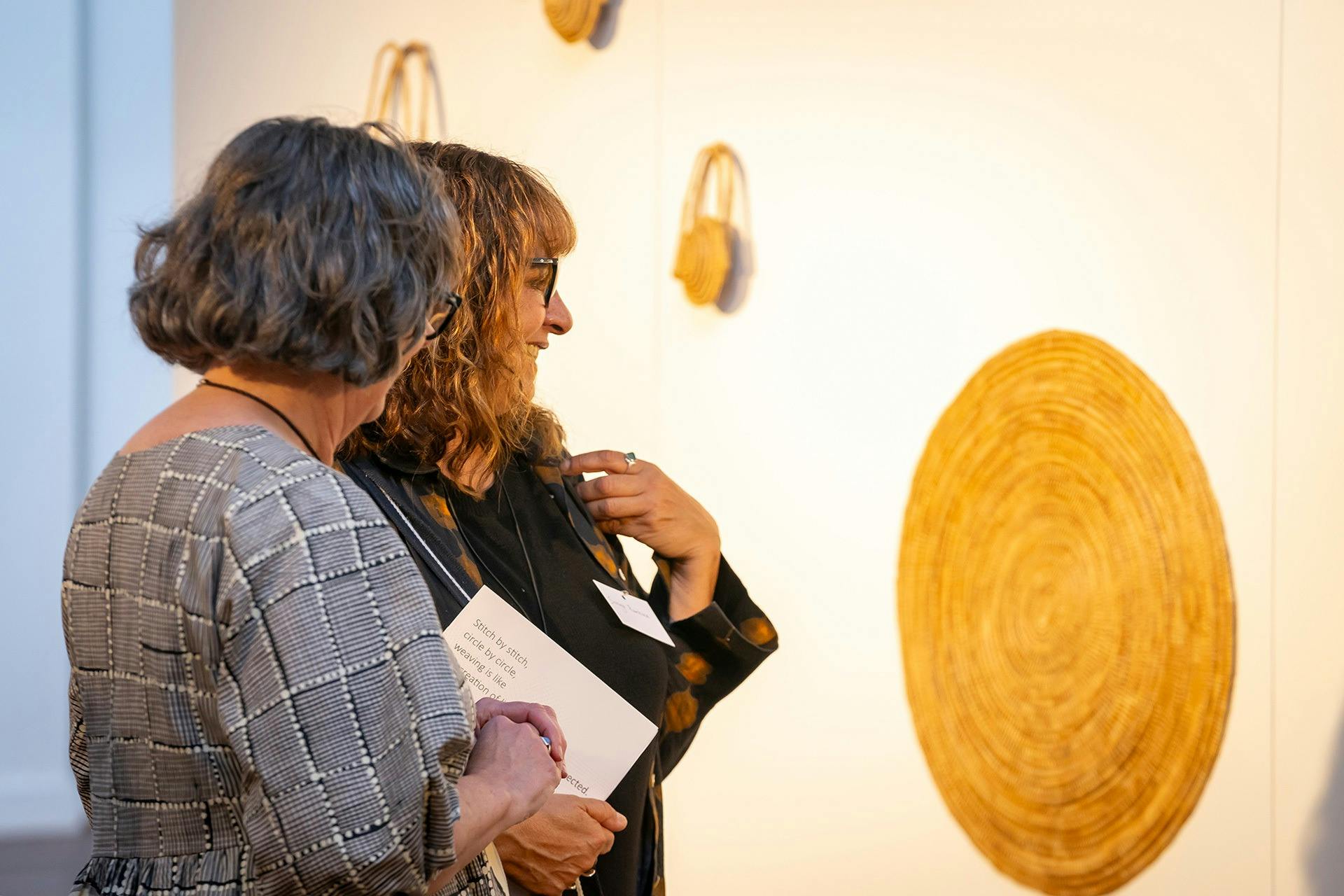 FABRIK patrons looking at exhibition pieces in the gallery space