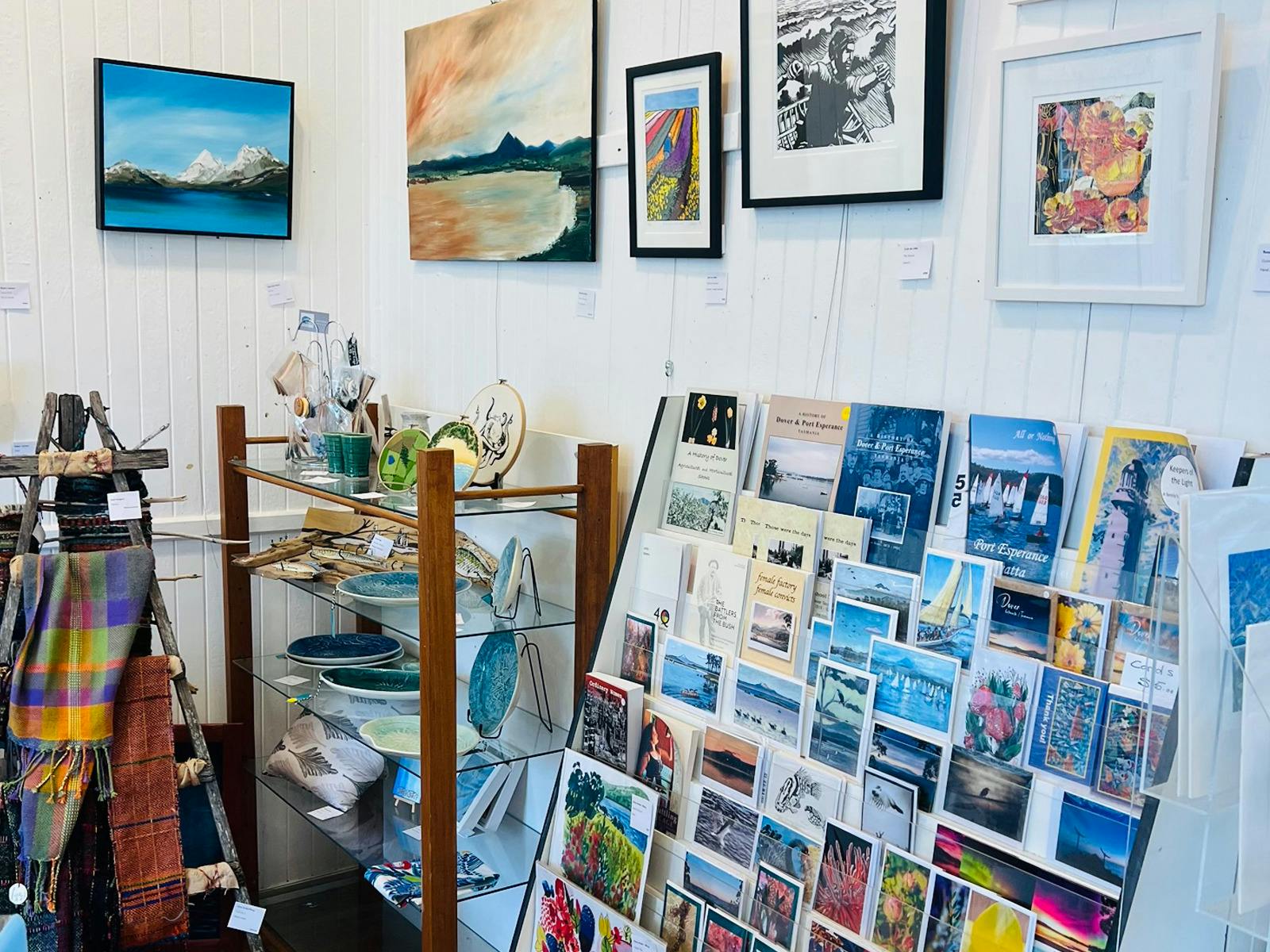 photo of shop dispaly with cards,books paintings and art