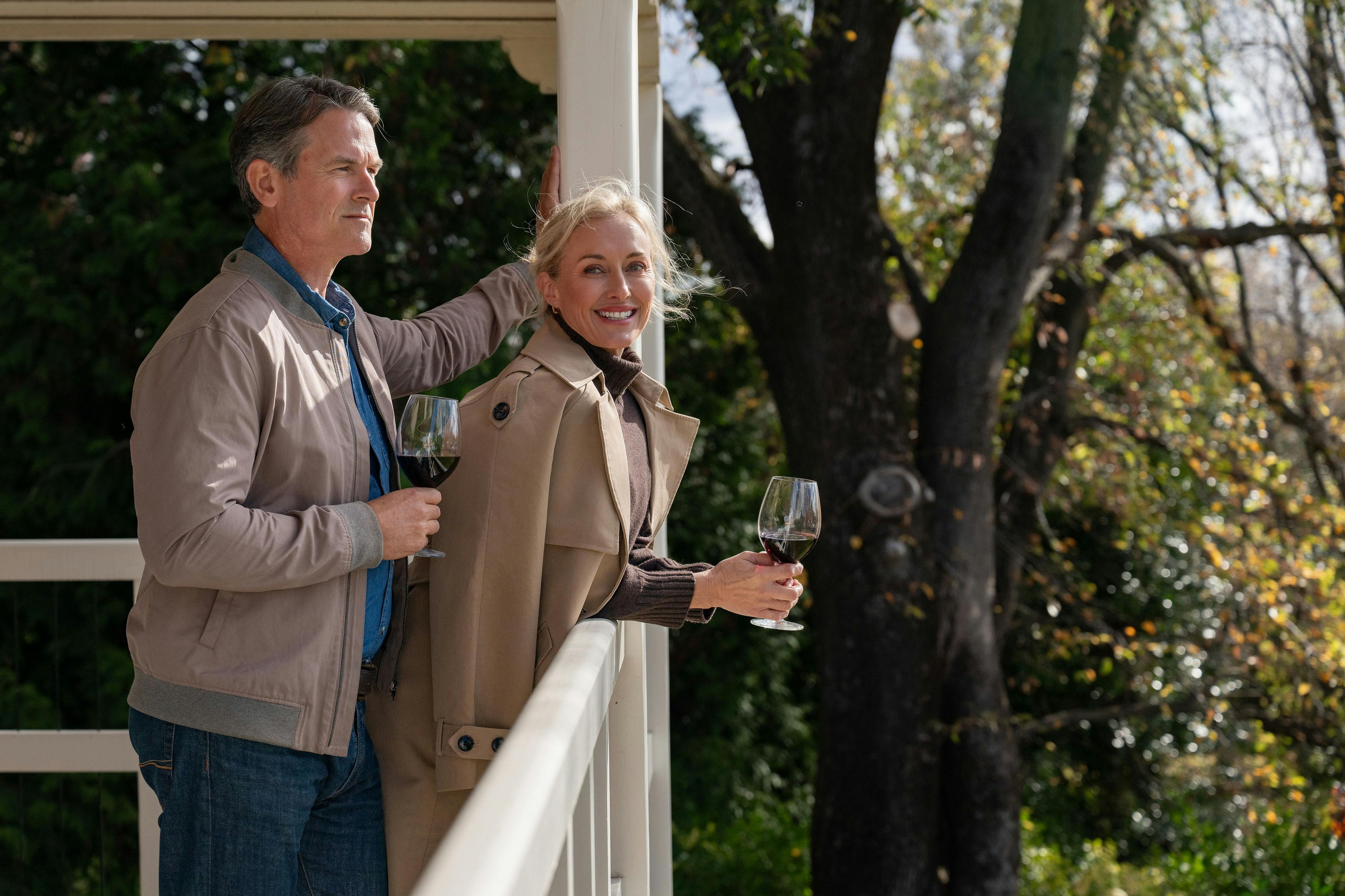 A couple enjoying a glass of red wine on the Yallungah Suite private balcony