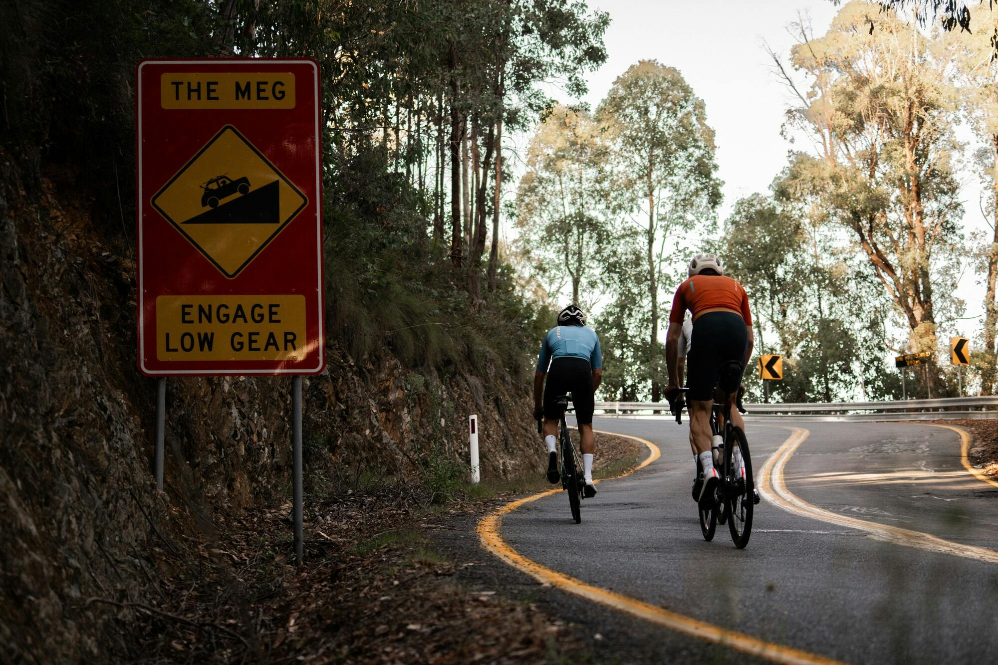Three cyclists riding past The Meg on the Mt Hotham 7 Peaks Challenge