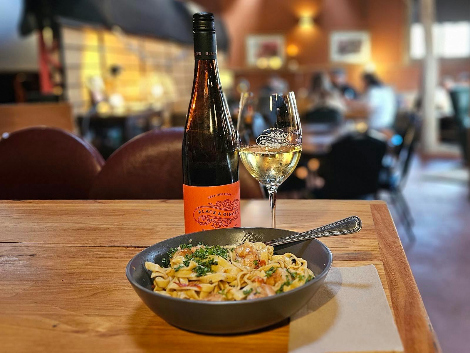 Bowl of pasta and a glass of Black & Ginger Miss Piggy in the wines shed