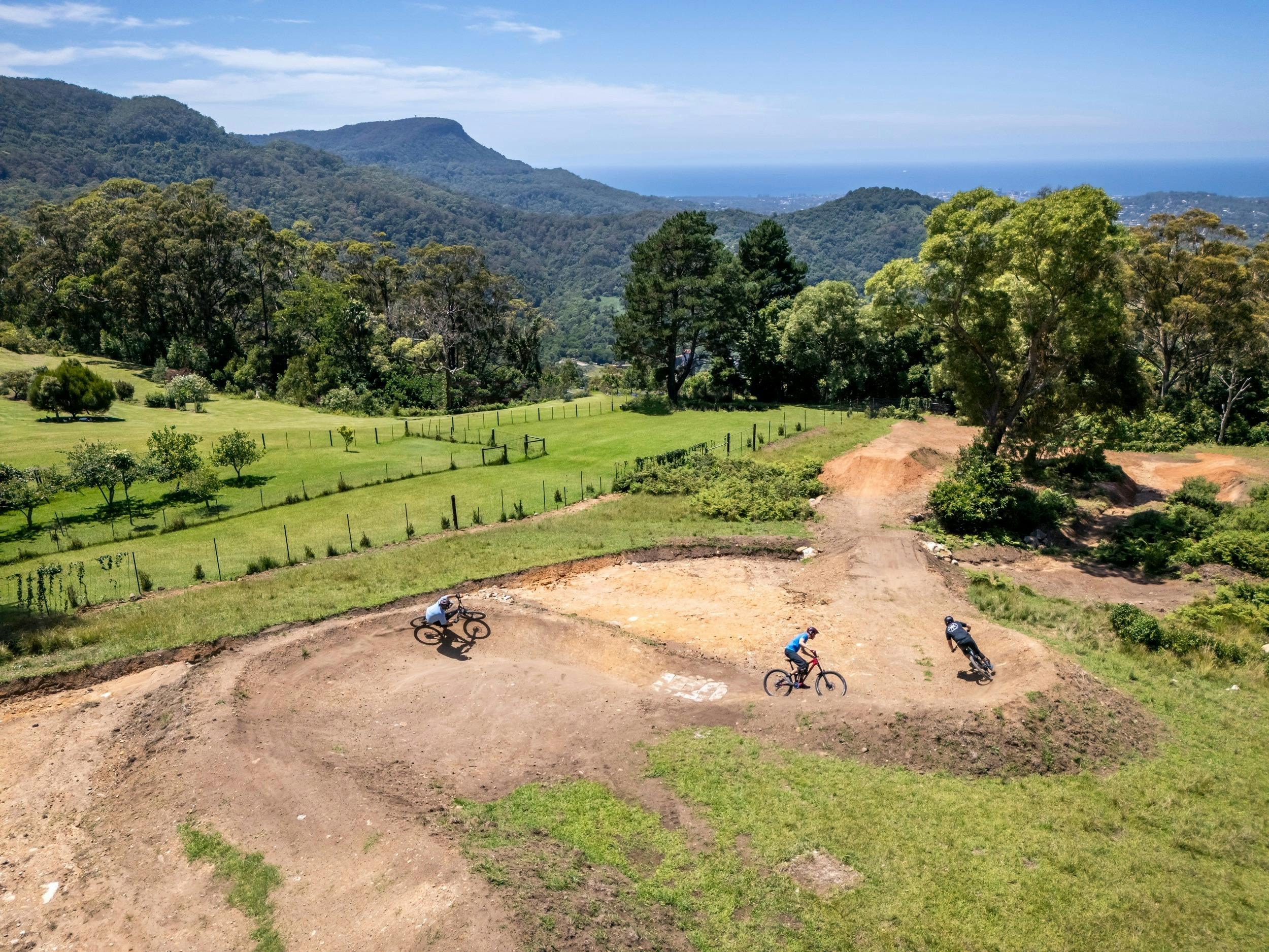 A group of riders tackle a hilly section of Kembla mountain bike trails.