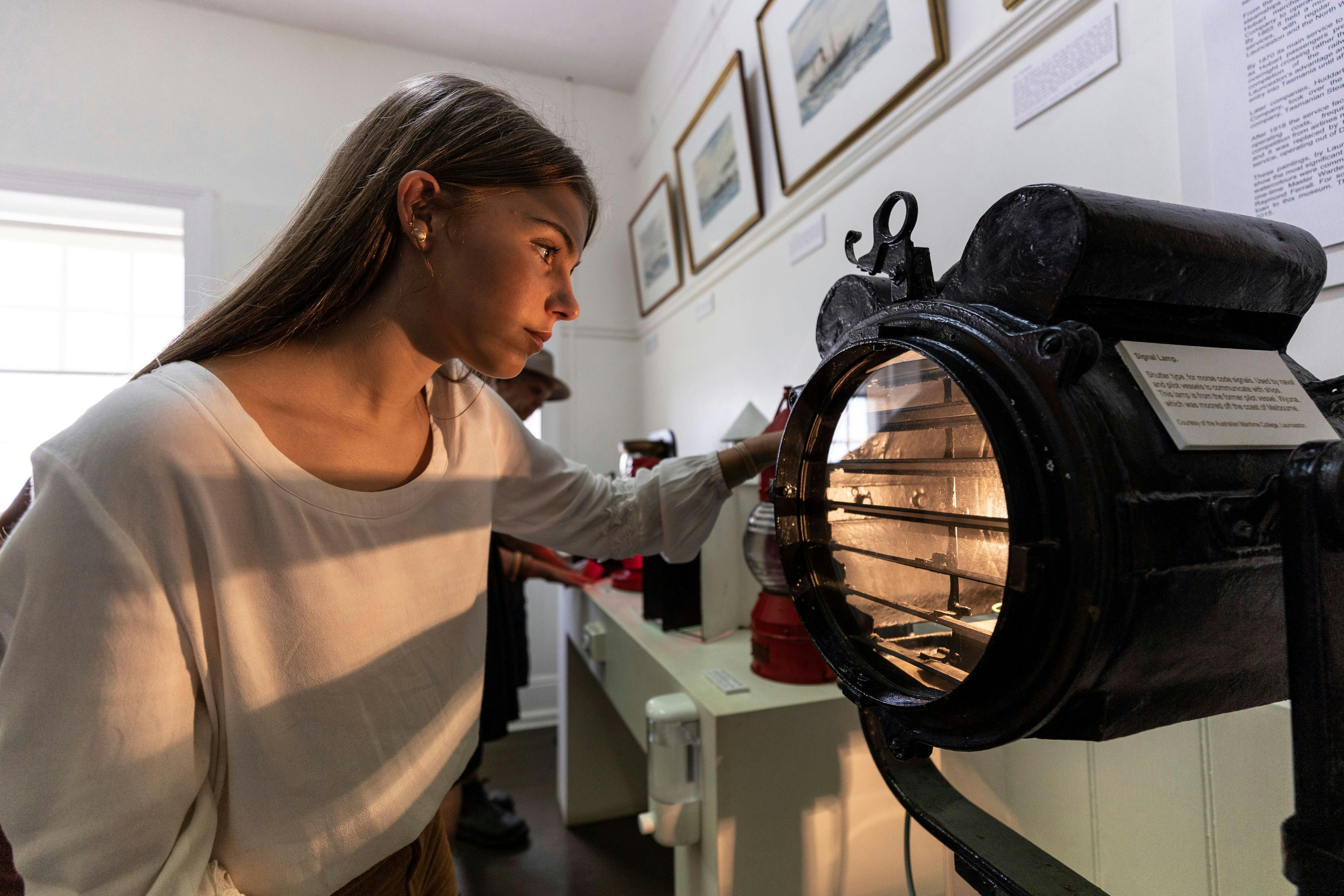 Girl looking at historic maritime collection