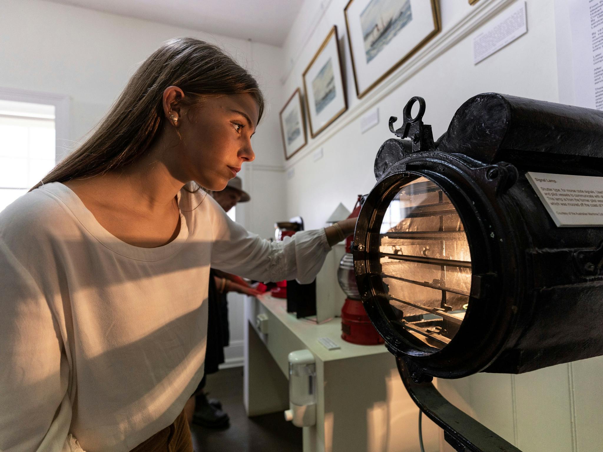 Girl looking at historic maritime collection