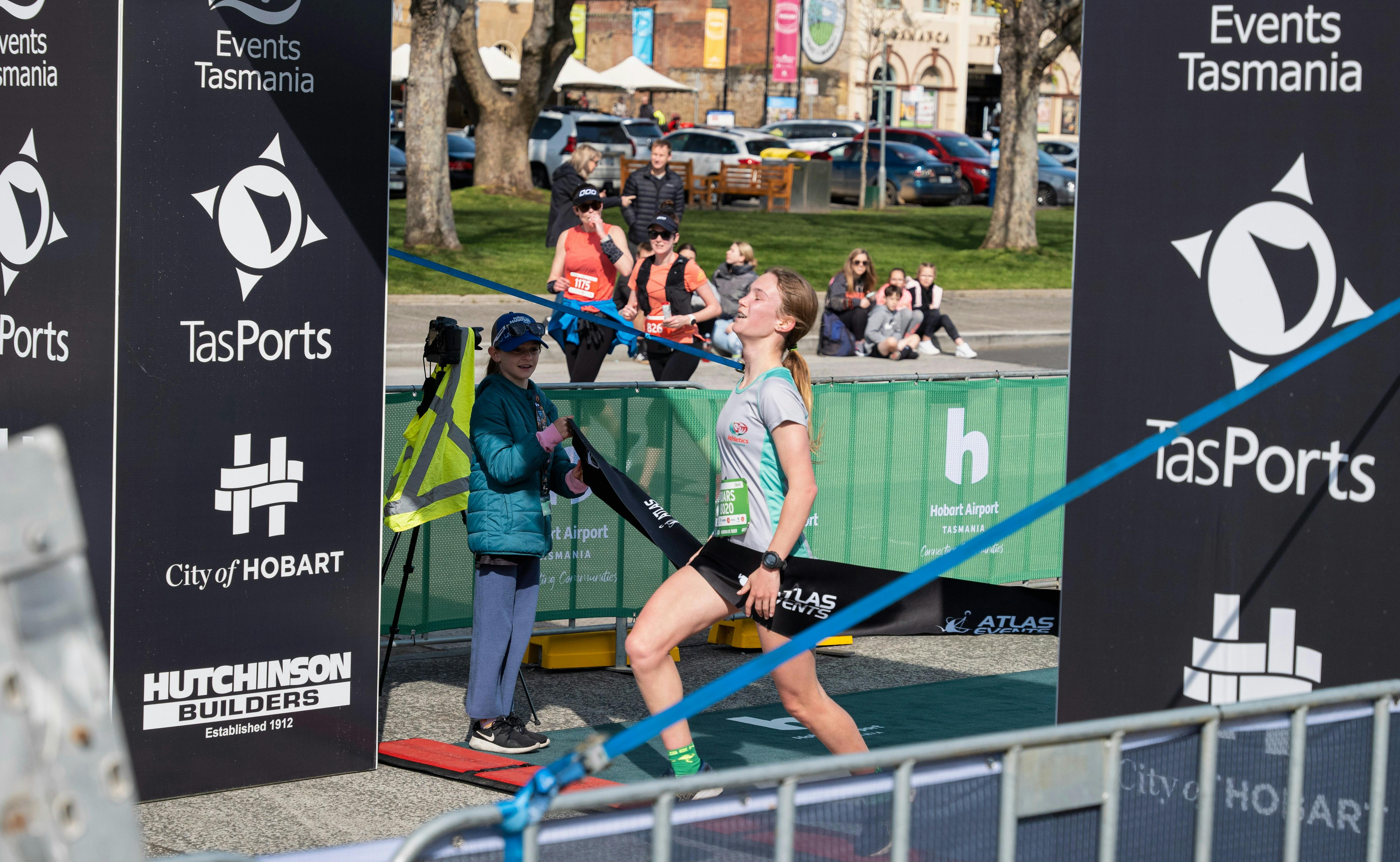 Female runner crossing the finish line