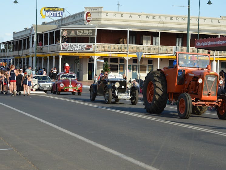 Vintage cars and a tractor in a street parade in Cobar