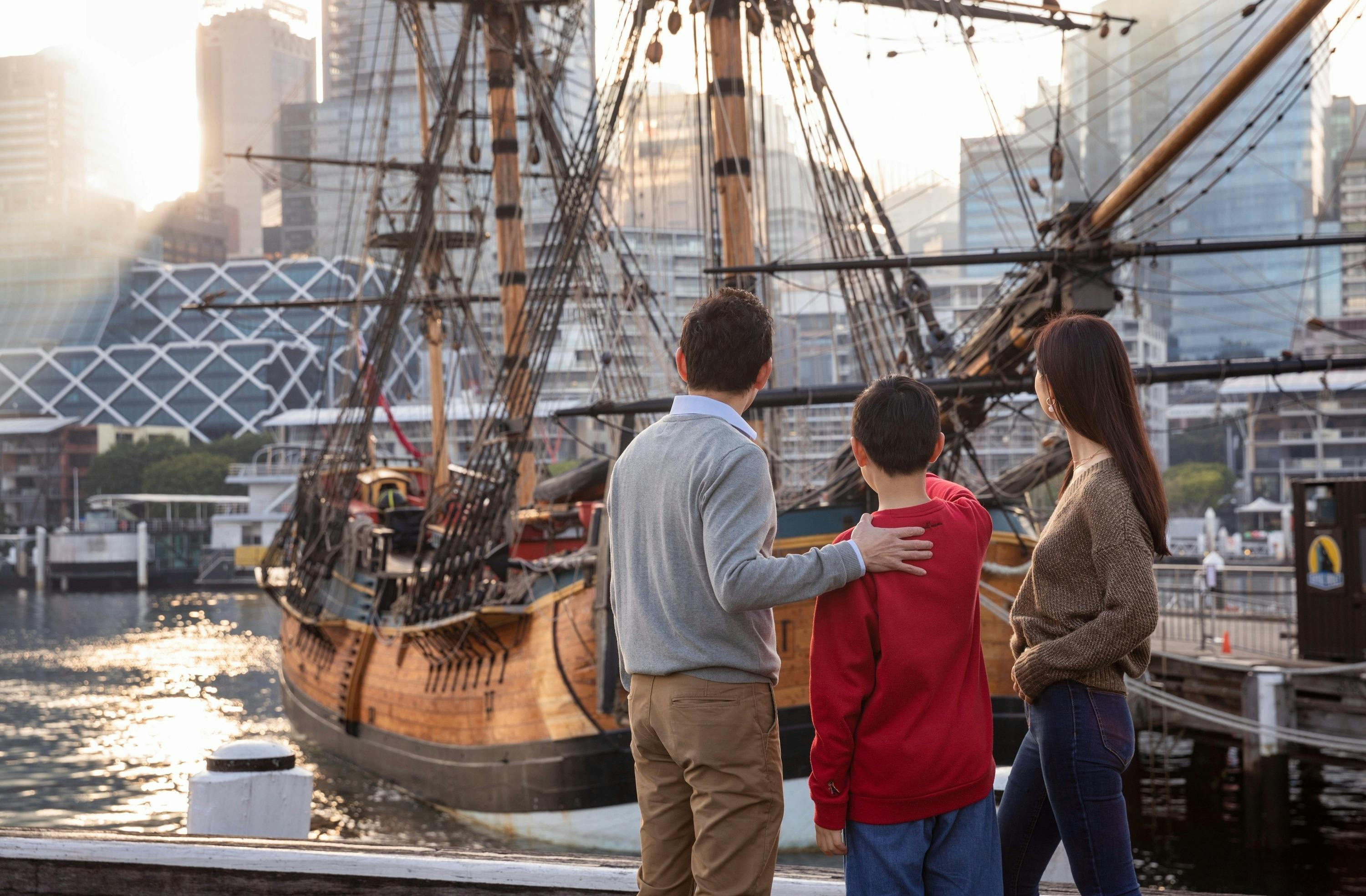 Family exploring Captain Cook's HMB Endeavour Replica in Darling Harbour.