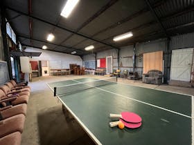 Recreation hall interior with chairs round edge and table tennis table