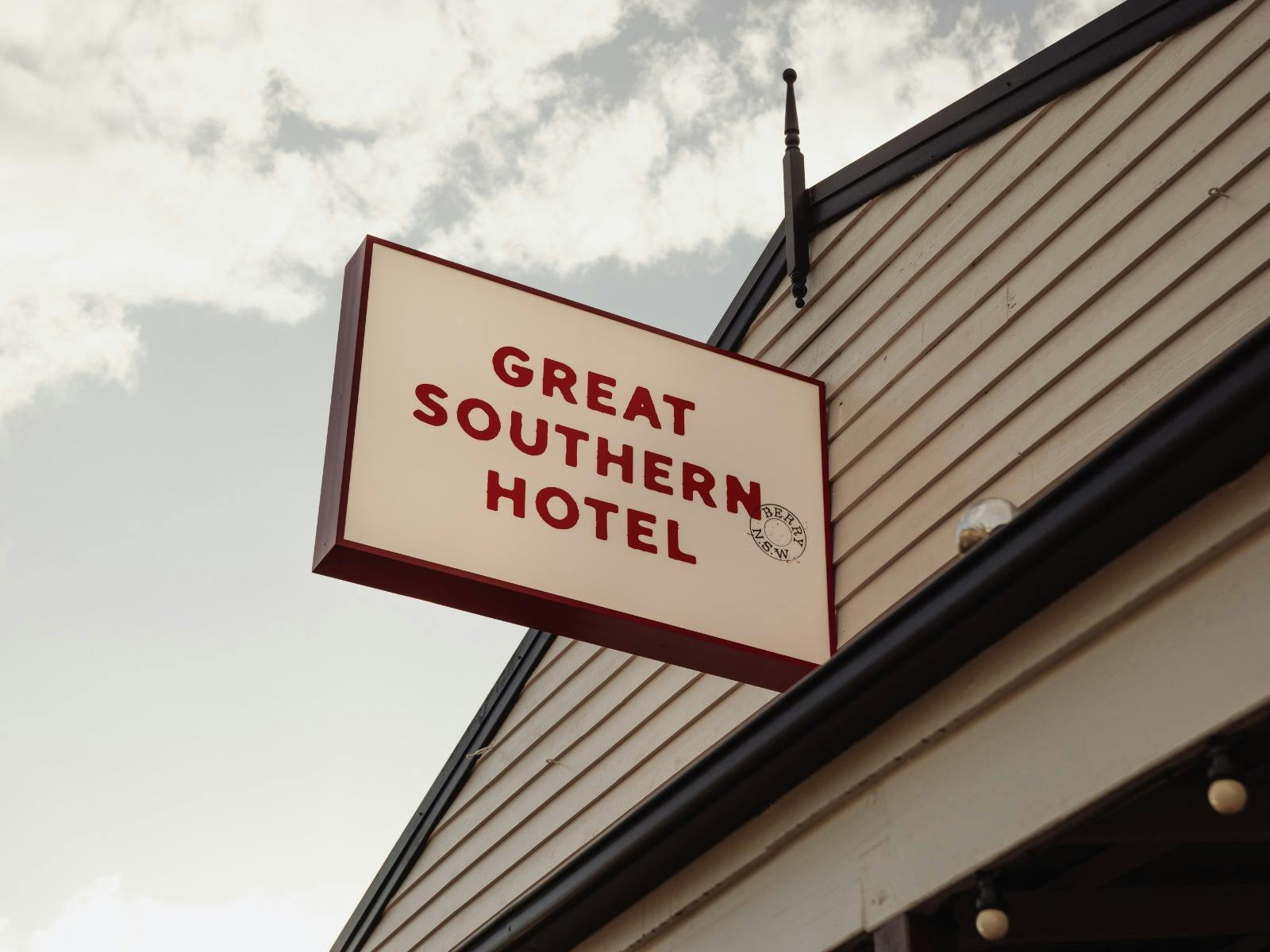 Close-up of the Great Southern Hotel sign mounted on the exterior of the building against the sky.