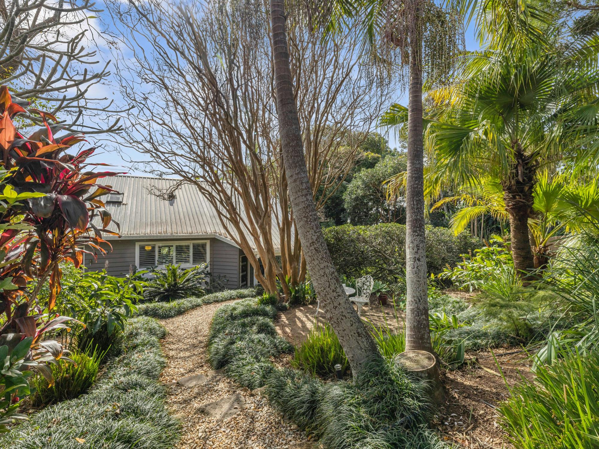 Front gardens and path leading toward the property entrance