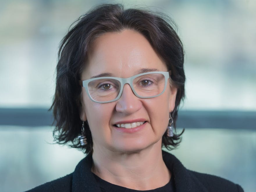 Woman with short dark hair and glasses