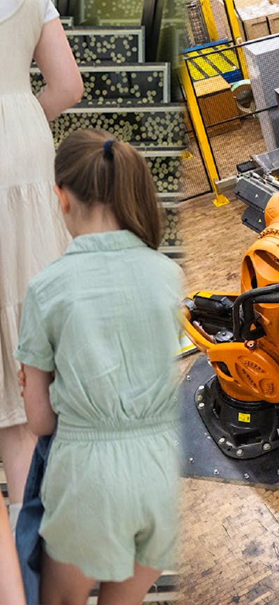 Three children with a guide and titan the robot pouring coins