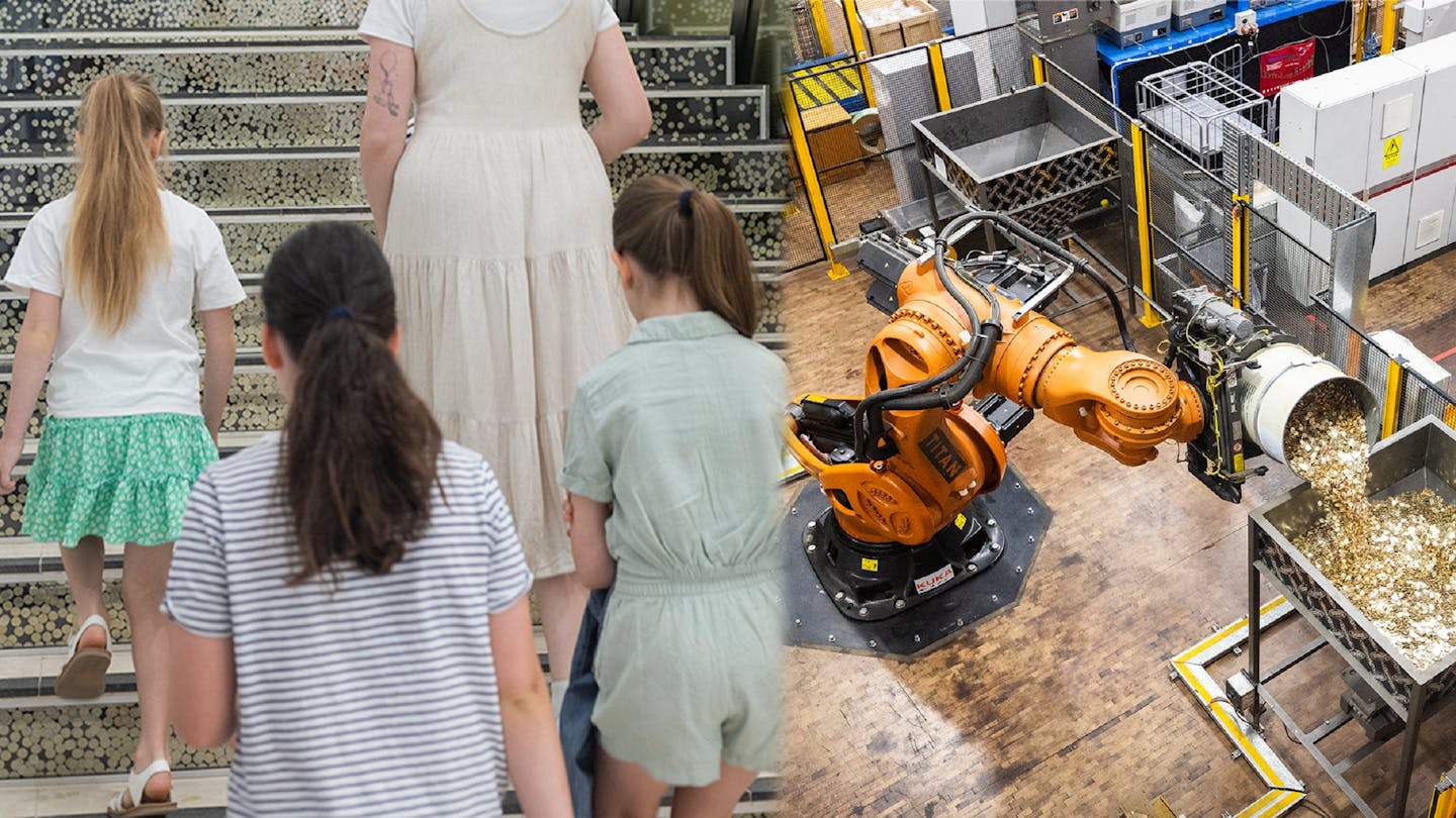Three children with a guide and titan the robot pouring coins
