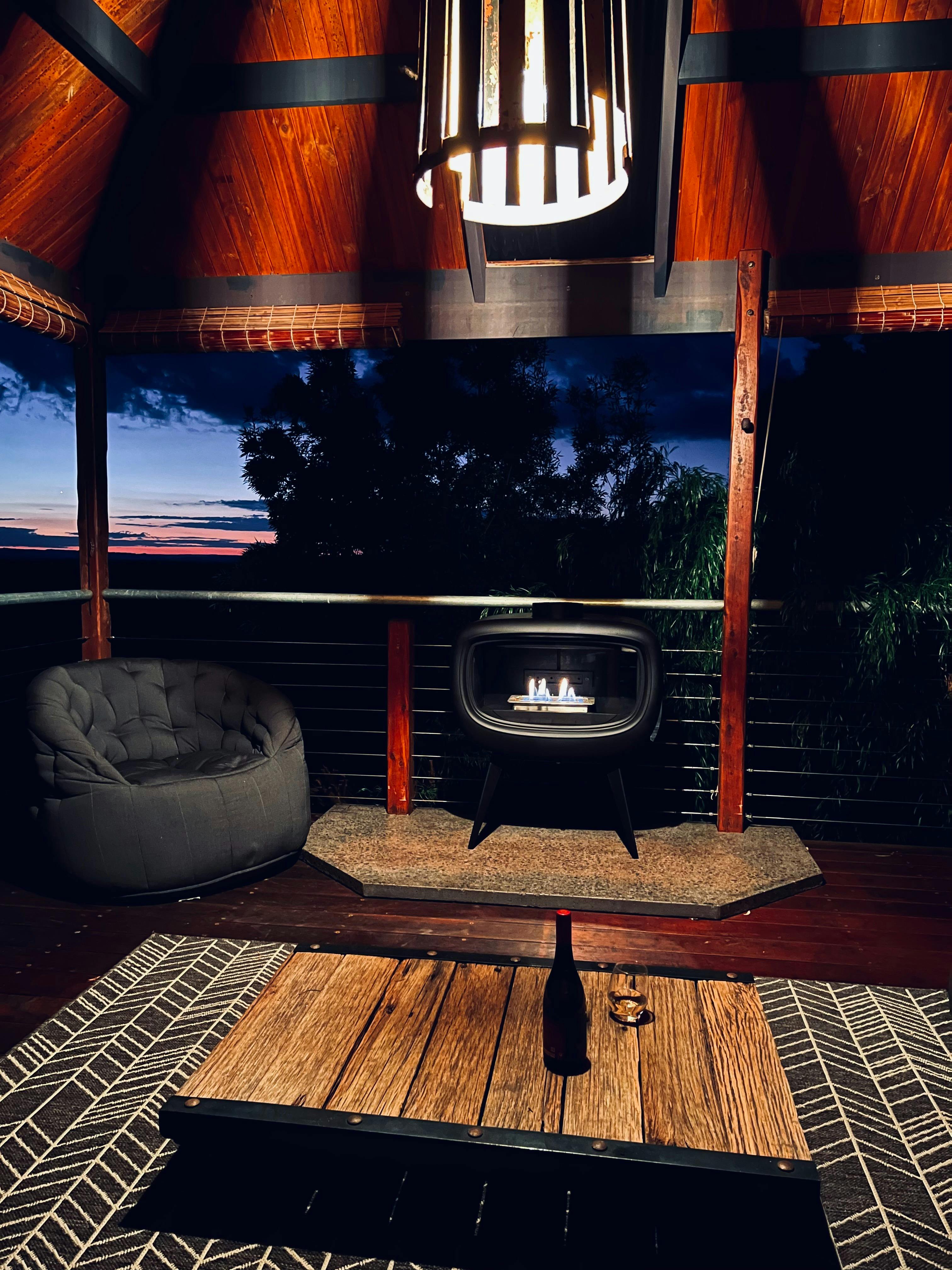Outdoor fireplace at Stone Creek Cottage with sunset