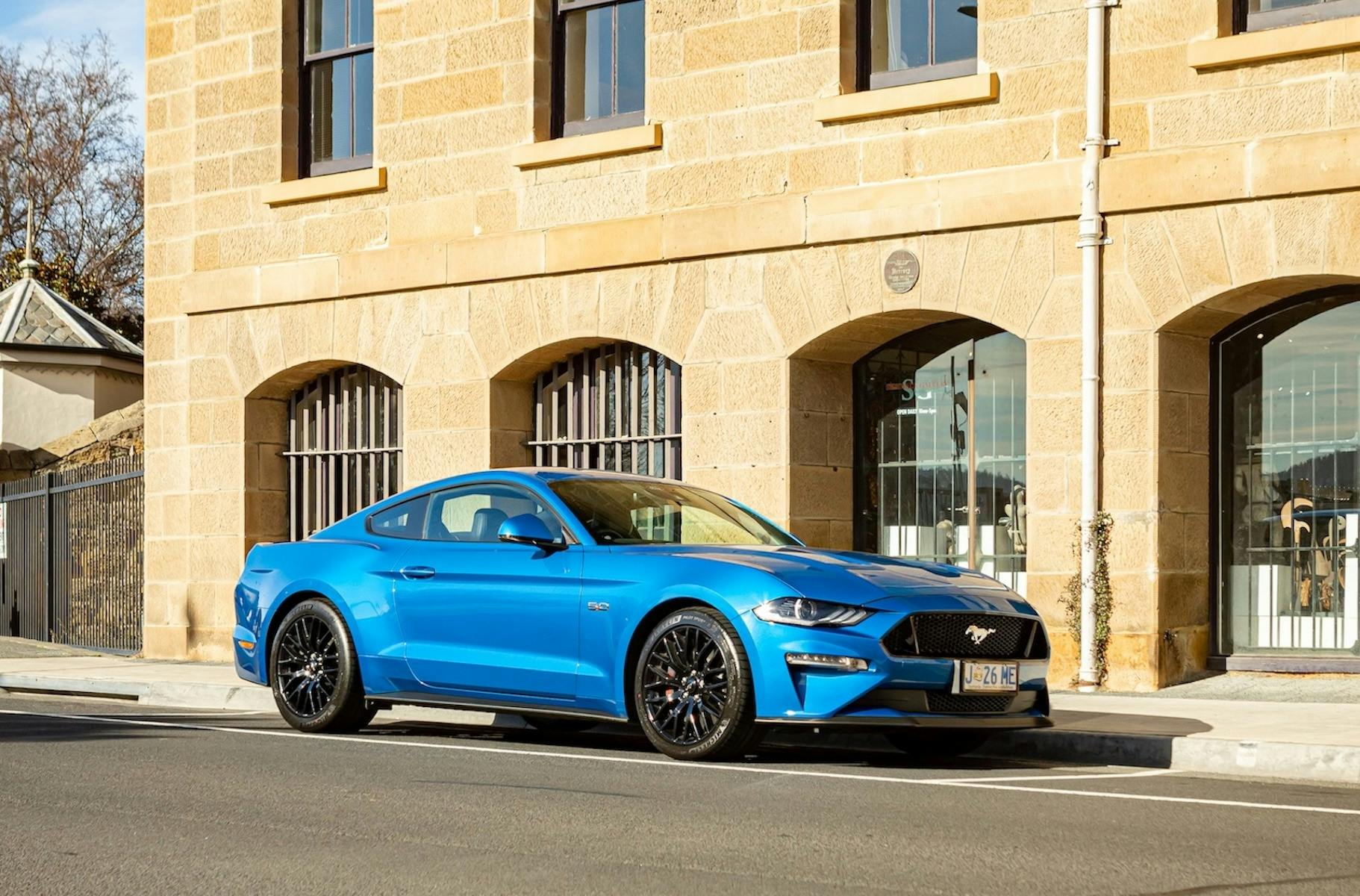 Blue Mustang GT beside heritage building in Hobart