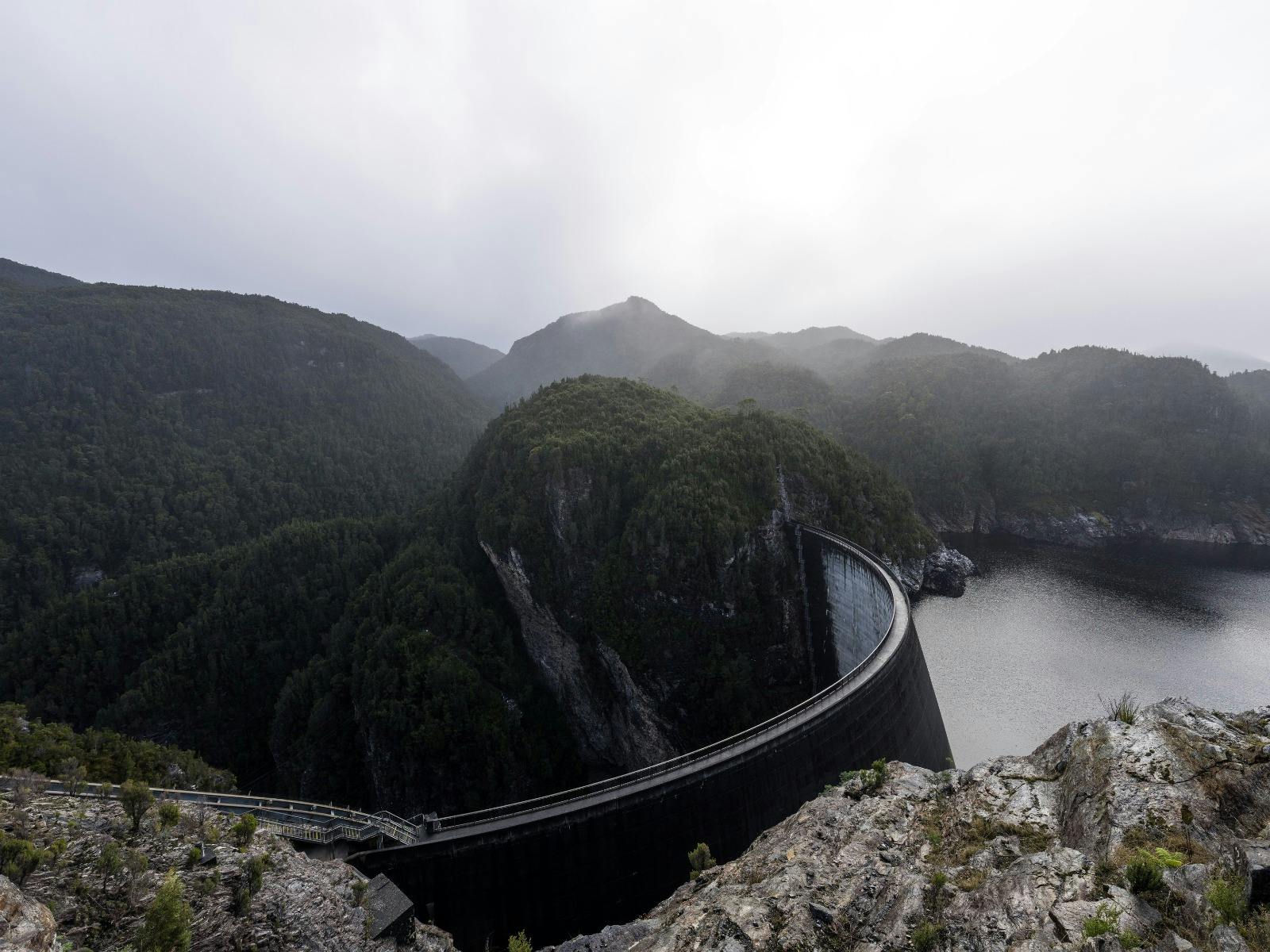Cloudy skies overlooking the Gordon Dam with the mountains in the background