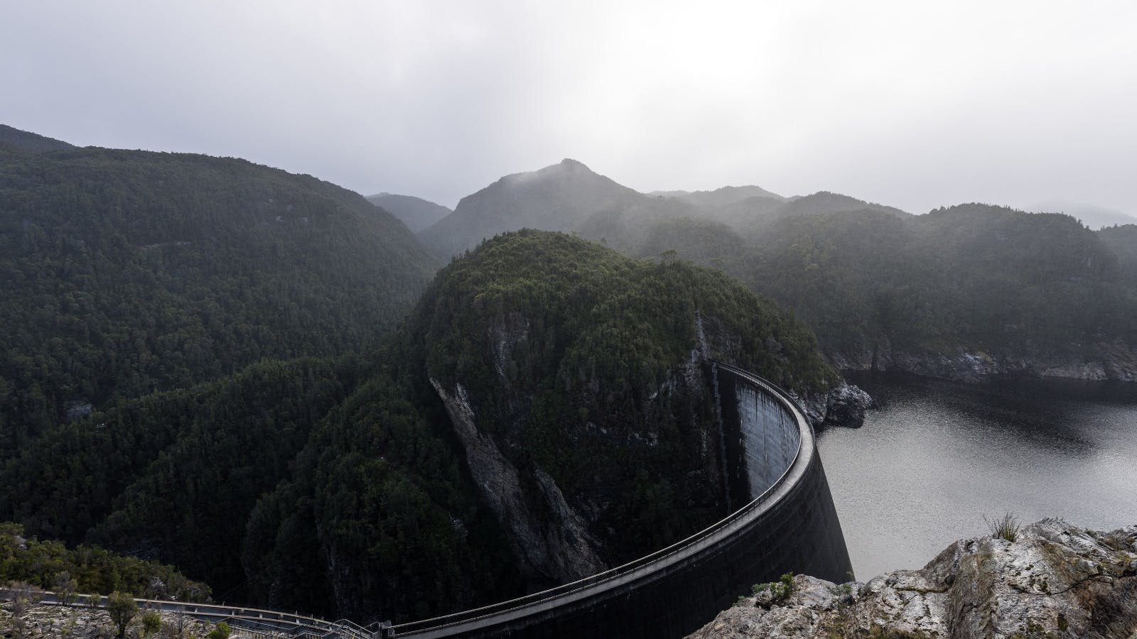 Cloudy skies overlooking the Gordon Dam with the mountains in the background