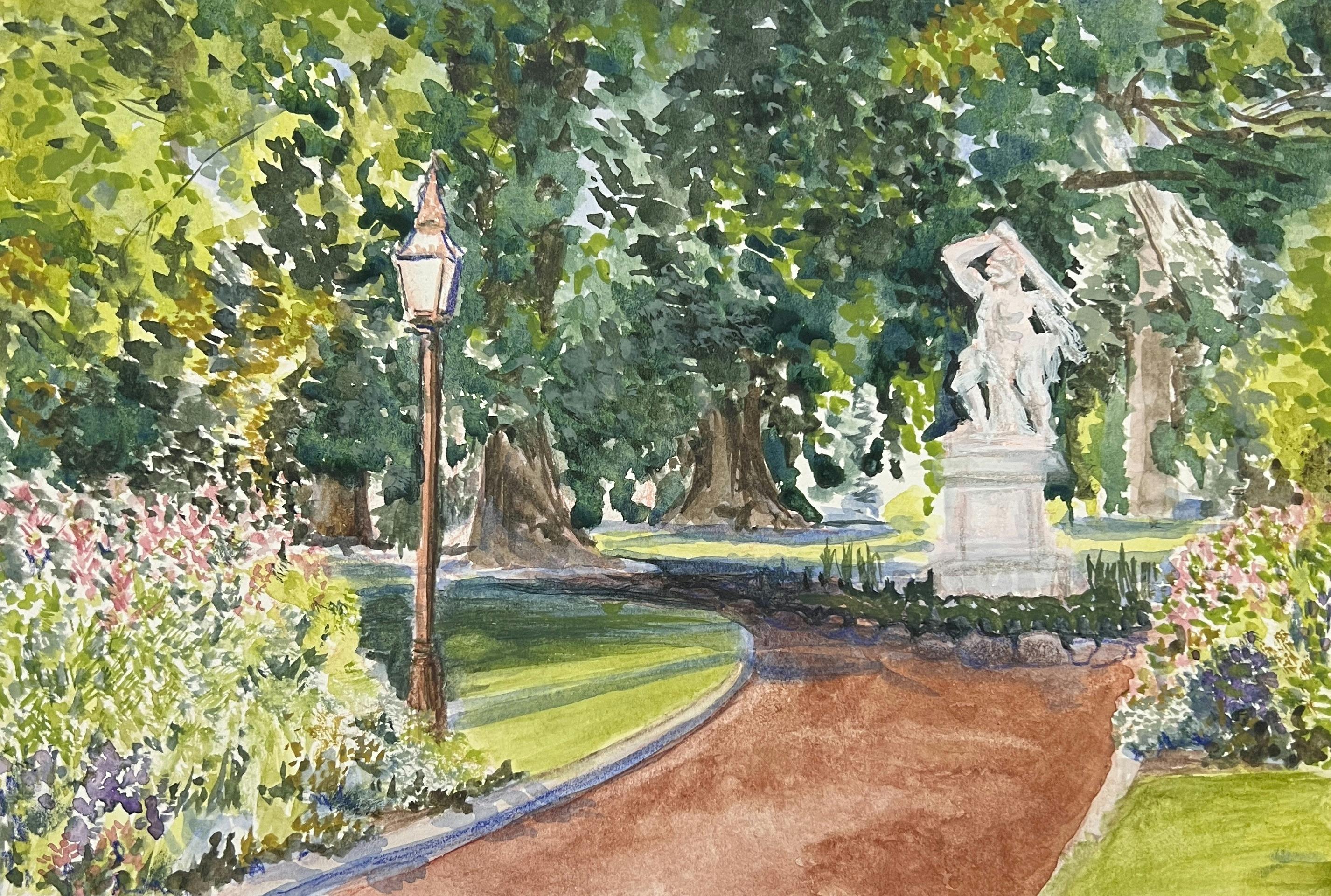brown path in gardens with marble sculpture and overhanging trees on a sunny day