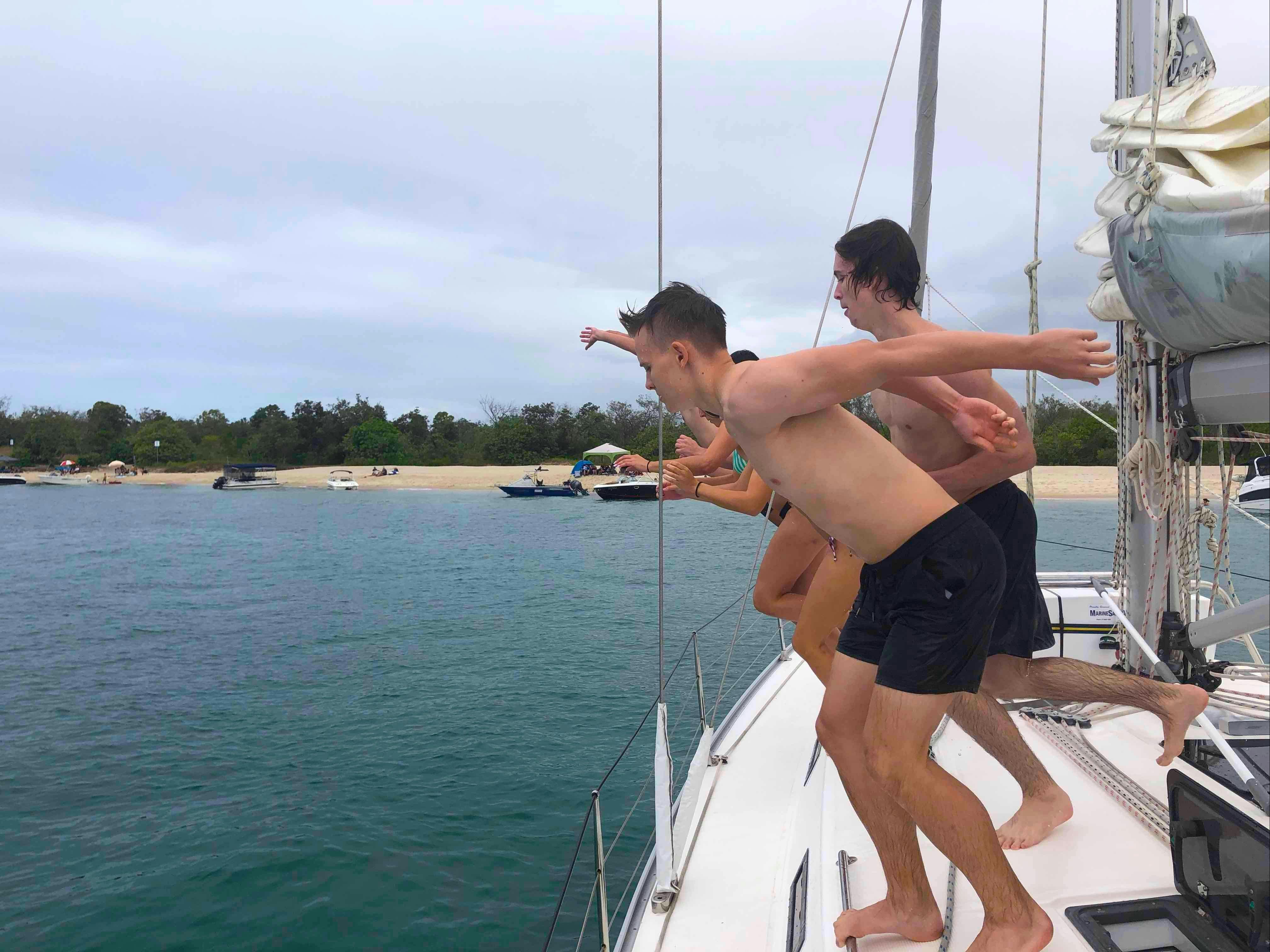 Boys jumping in at Peel Island