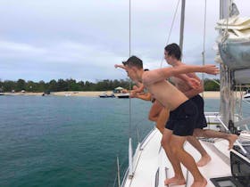 Boys jumping in at Peel Island