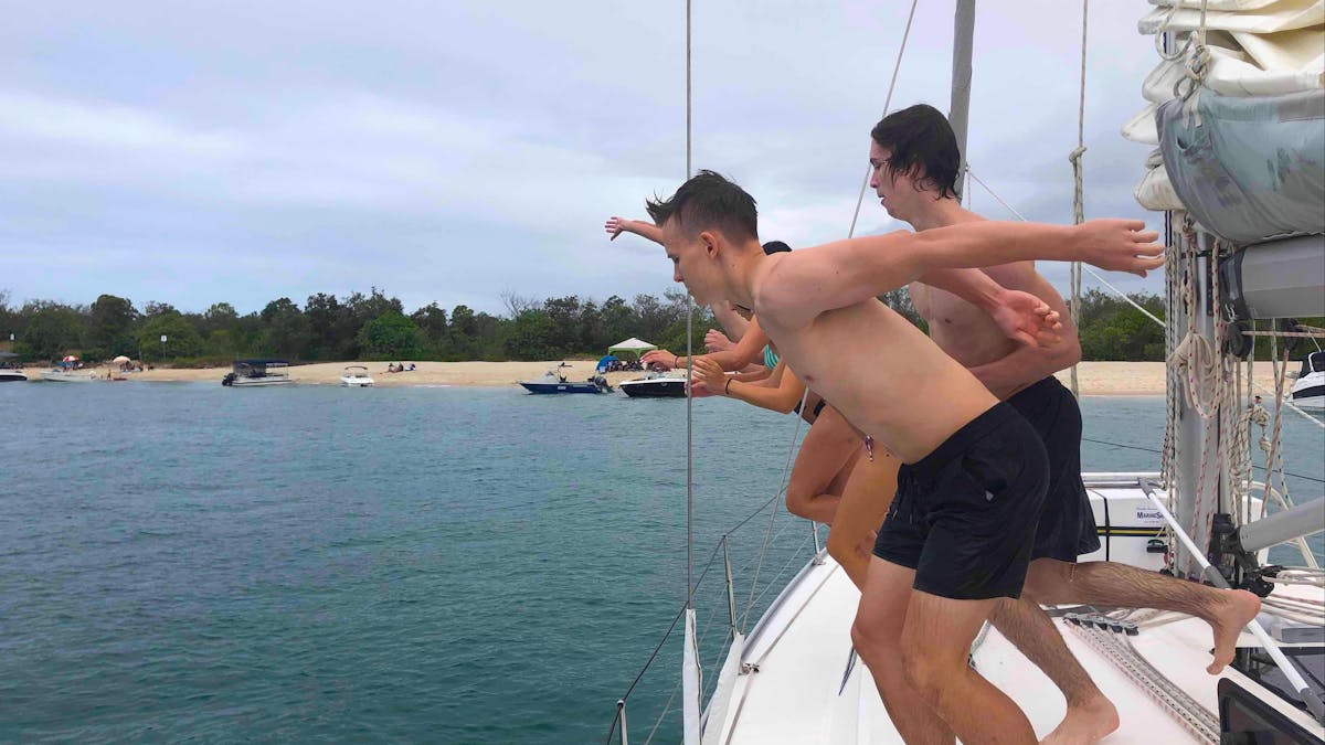 Boys jumping in at Peel Island