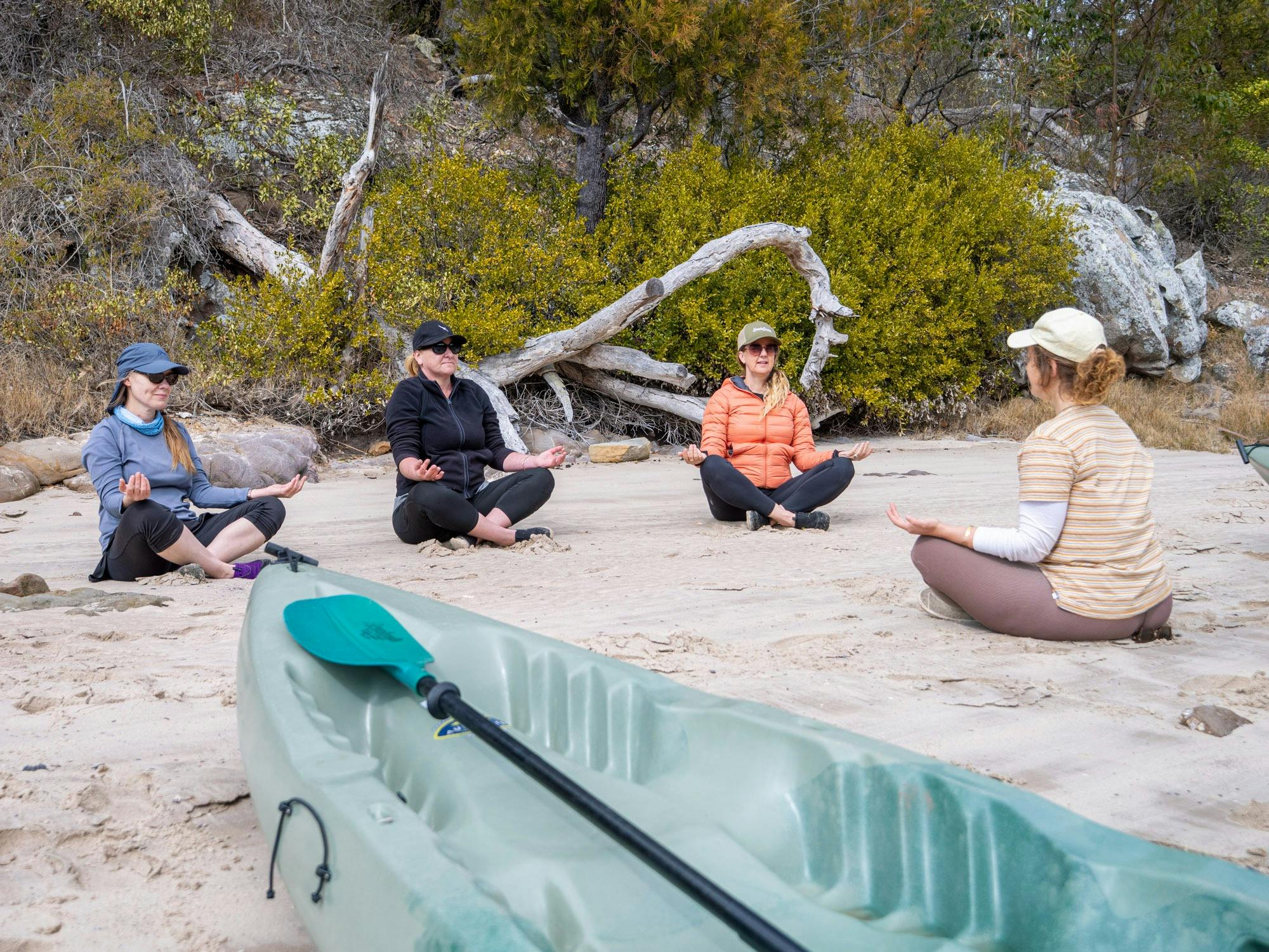 Kayak in the foreground with guests in the background guided meditation