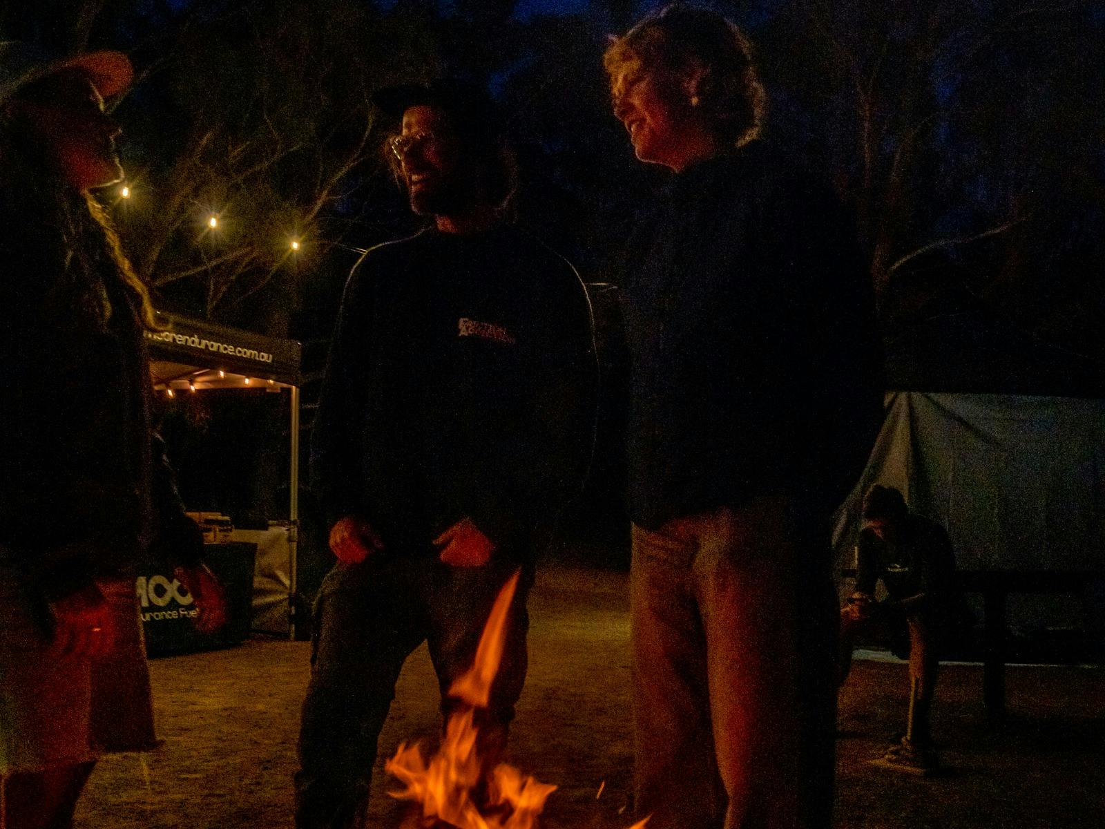A group of people standing around a fire