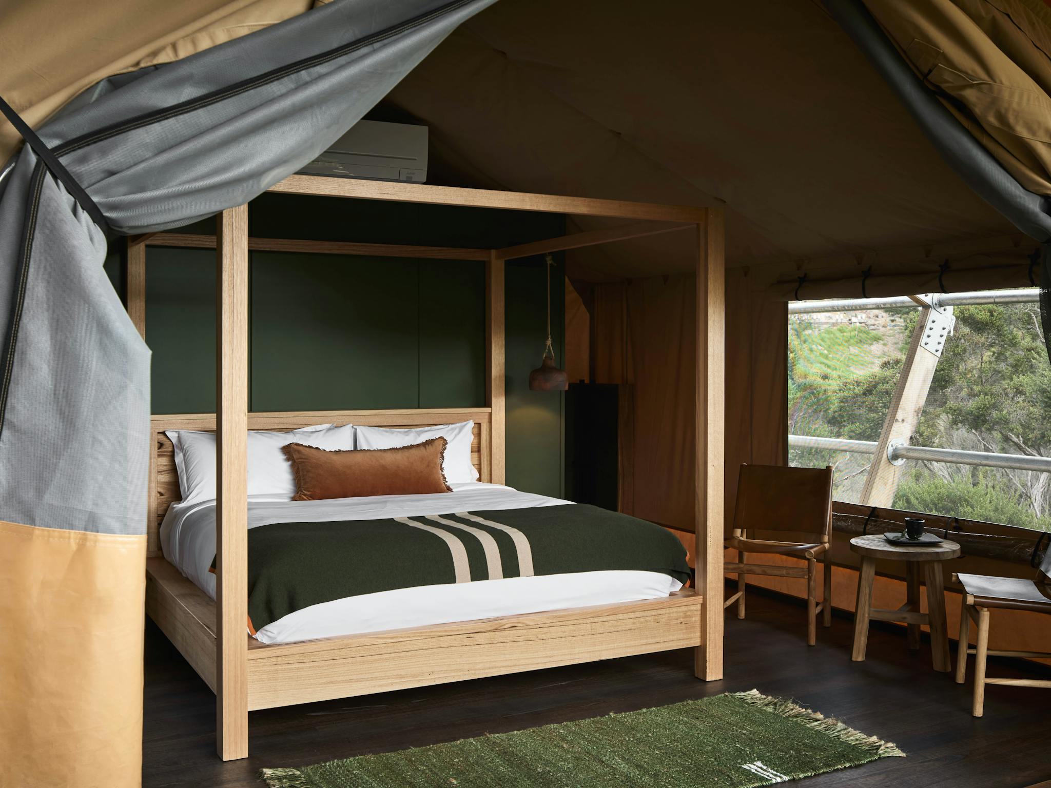 Each luxurious safari-style glamping tent features a premium king-size four poster bed.