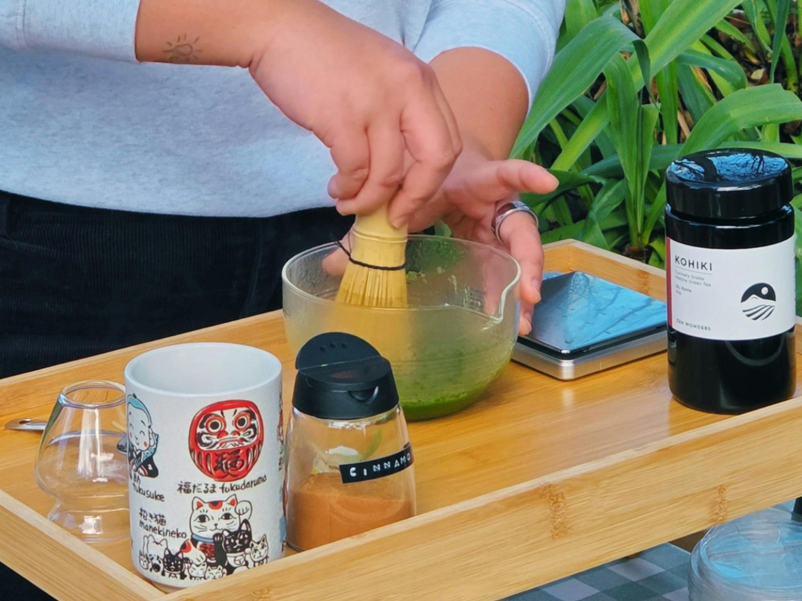 person making matcha