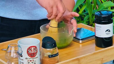 person making matcha