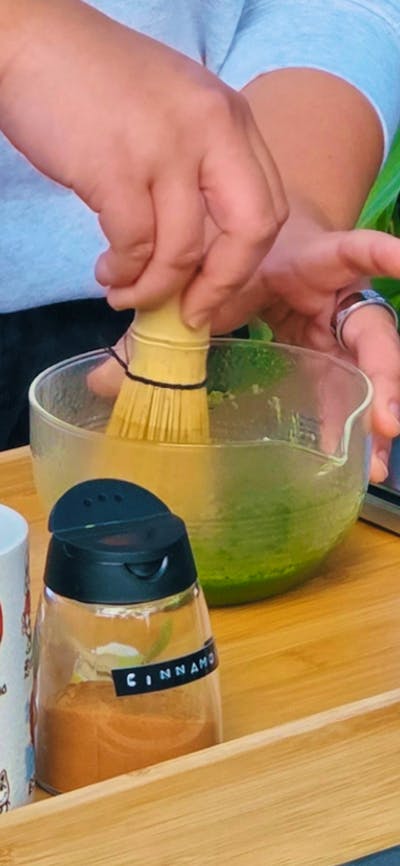 person making matcha