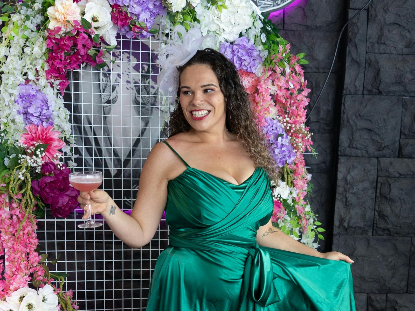 A lady enjoying a cocktail at Maggie Choo's Melbourne Cup event