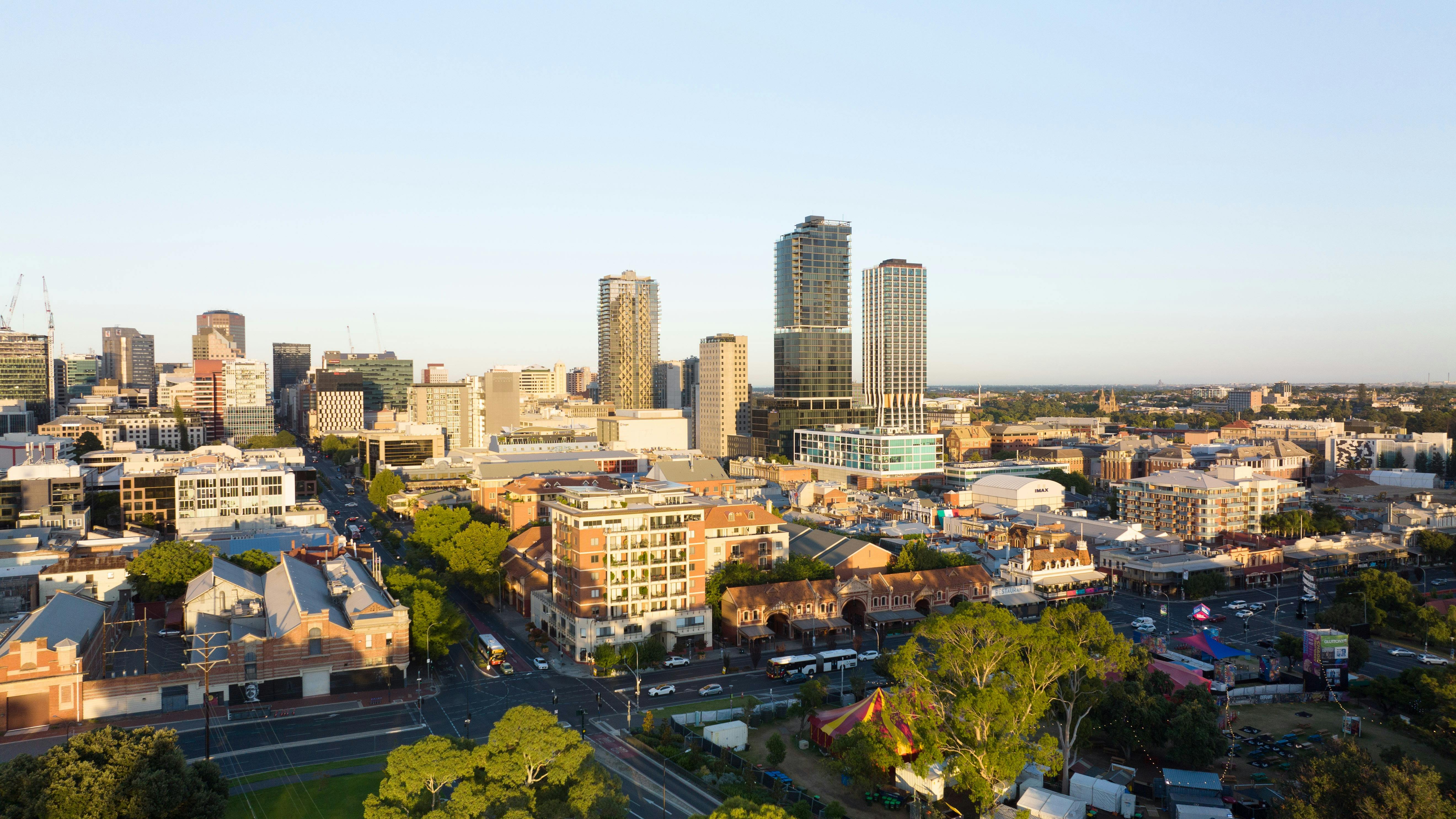 A city skyline of Adelaide, featuring four prominent high-rise buildings in the middle.