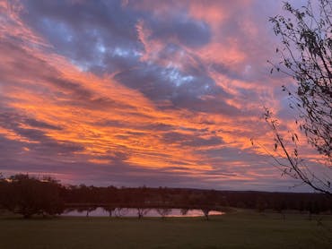 Spectacular orange sunset over dam