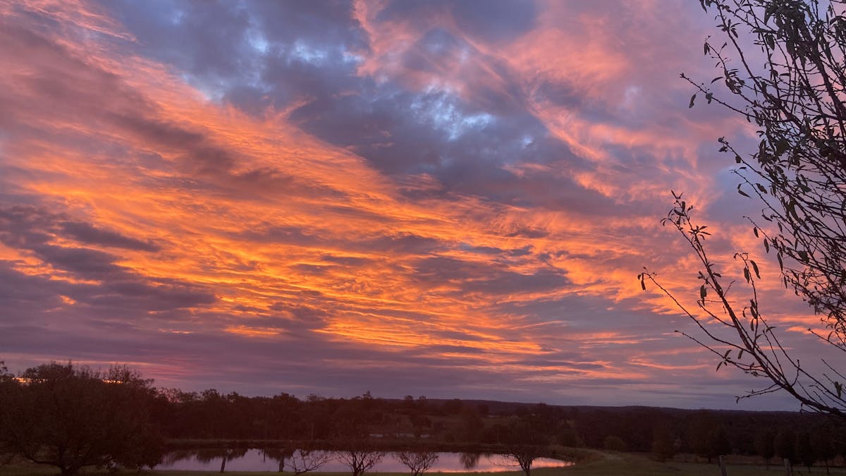 Spectacular orange sunset over dam