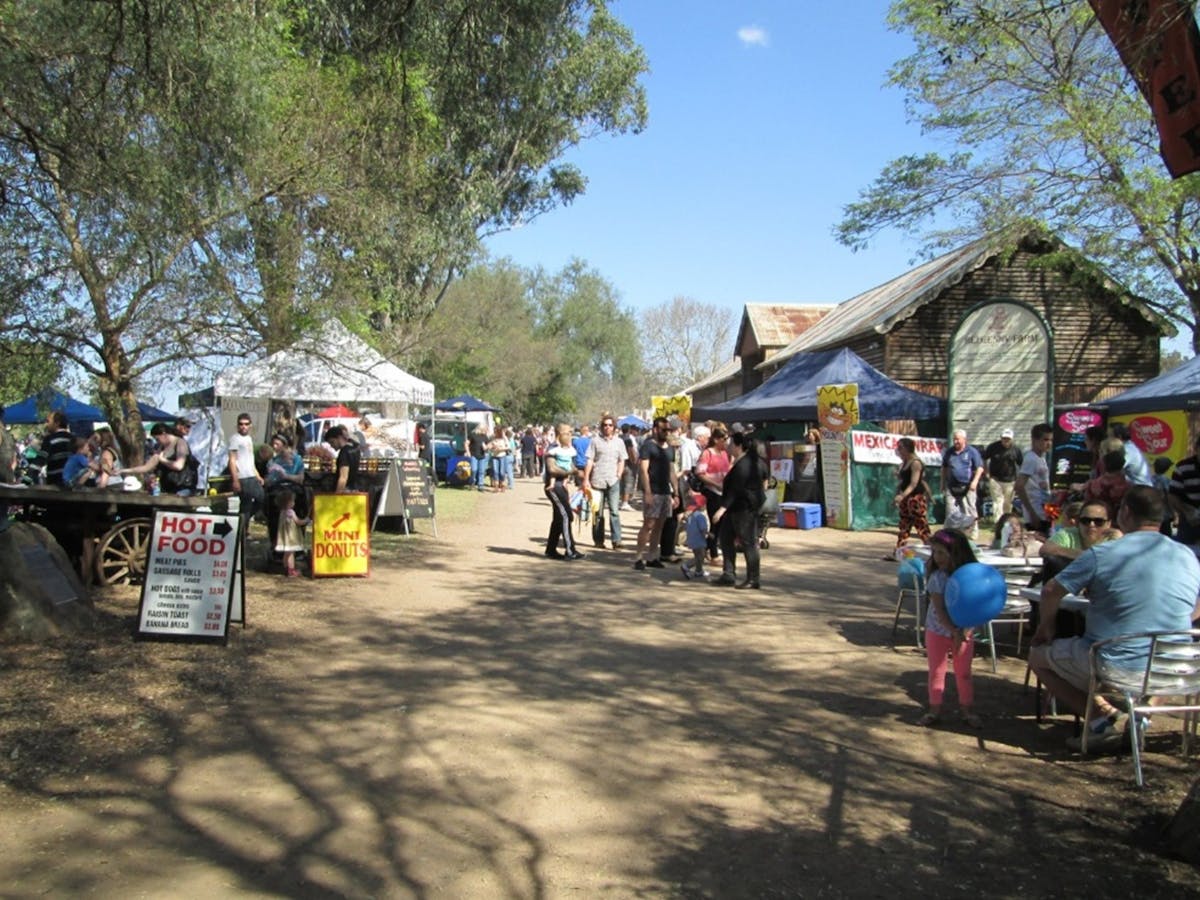 People strolling the farm with stalls and food vendors