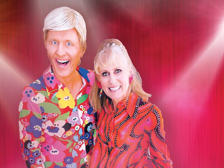 Comedian in Blonde wig with woman in red blouse