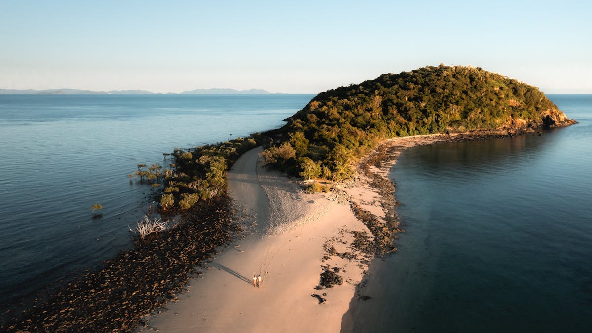 Aerial view of the small hilly Langford island with a sandbar