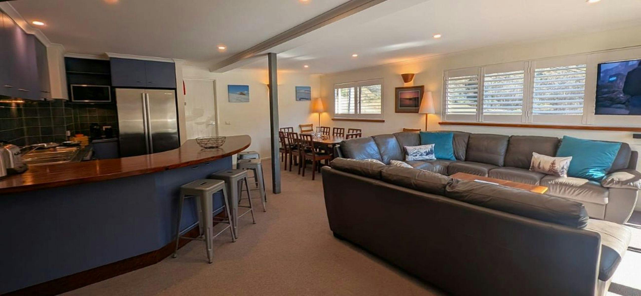 Spacious common area with couches, tables, chairs and stools