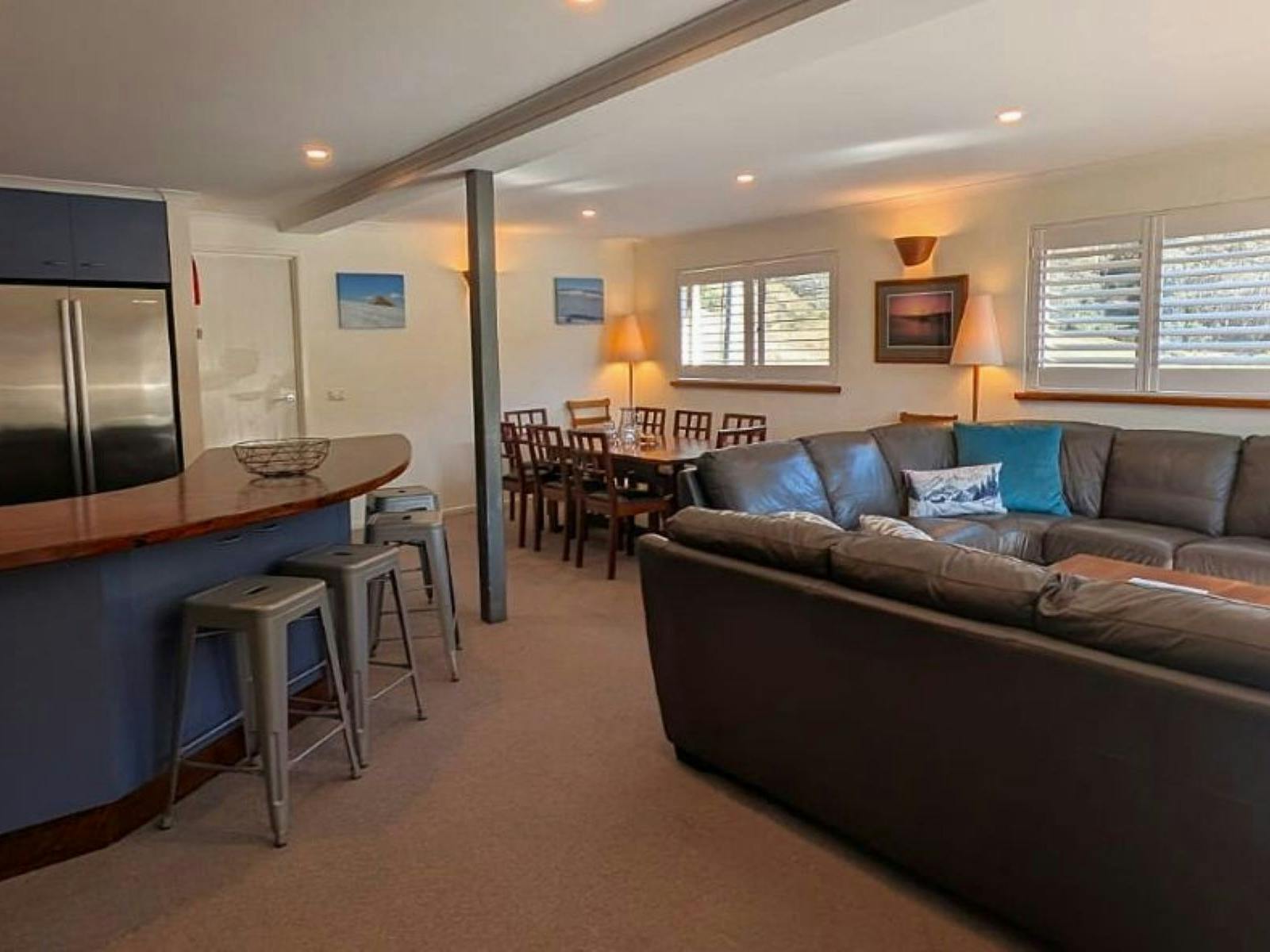 Spacious common area with couches, tables, chairs and stools