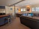 Spacious common area with couches, tables, chairs and stools