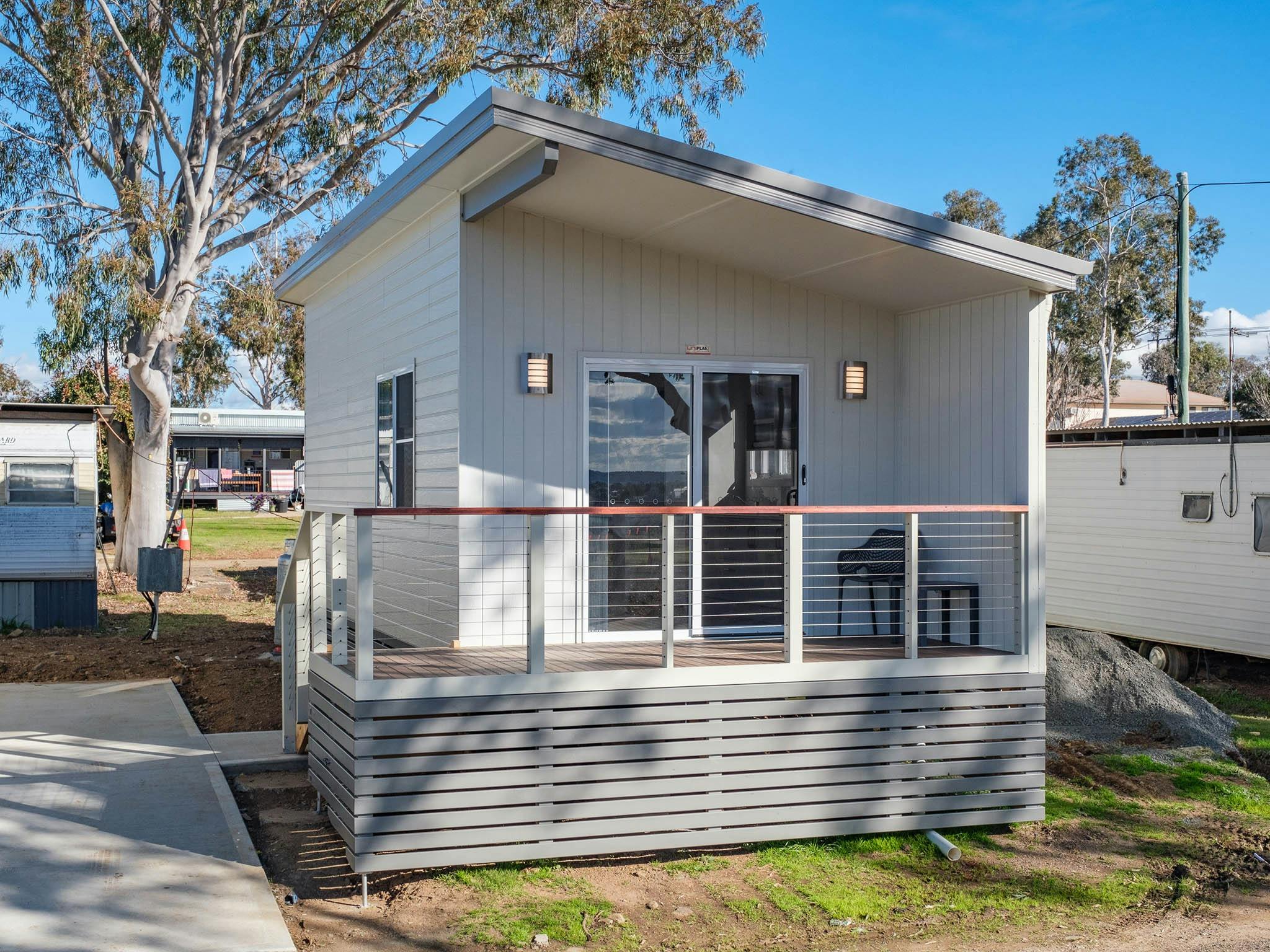 Contemporary Deluxe Studio accommodation with outdoor lighting and shaded balcony at Tamworth Holida