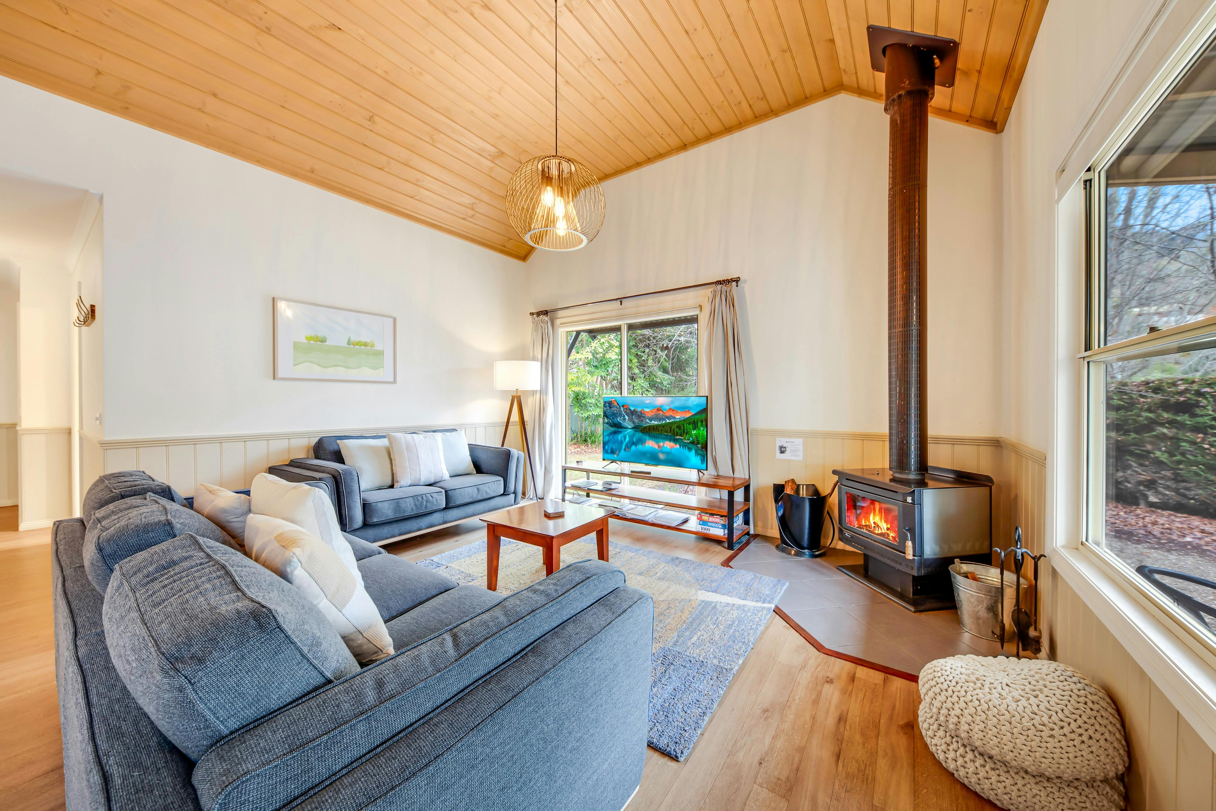 Lounge area with a small fireplace, television, couches and tea table