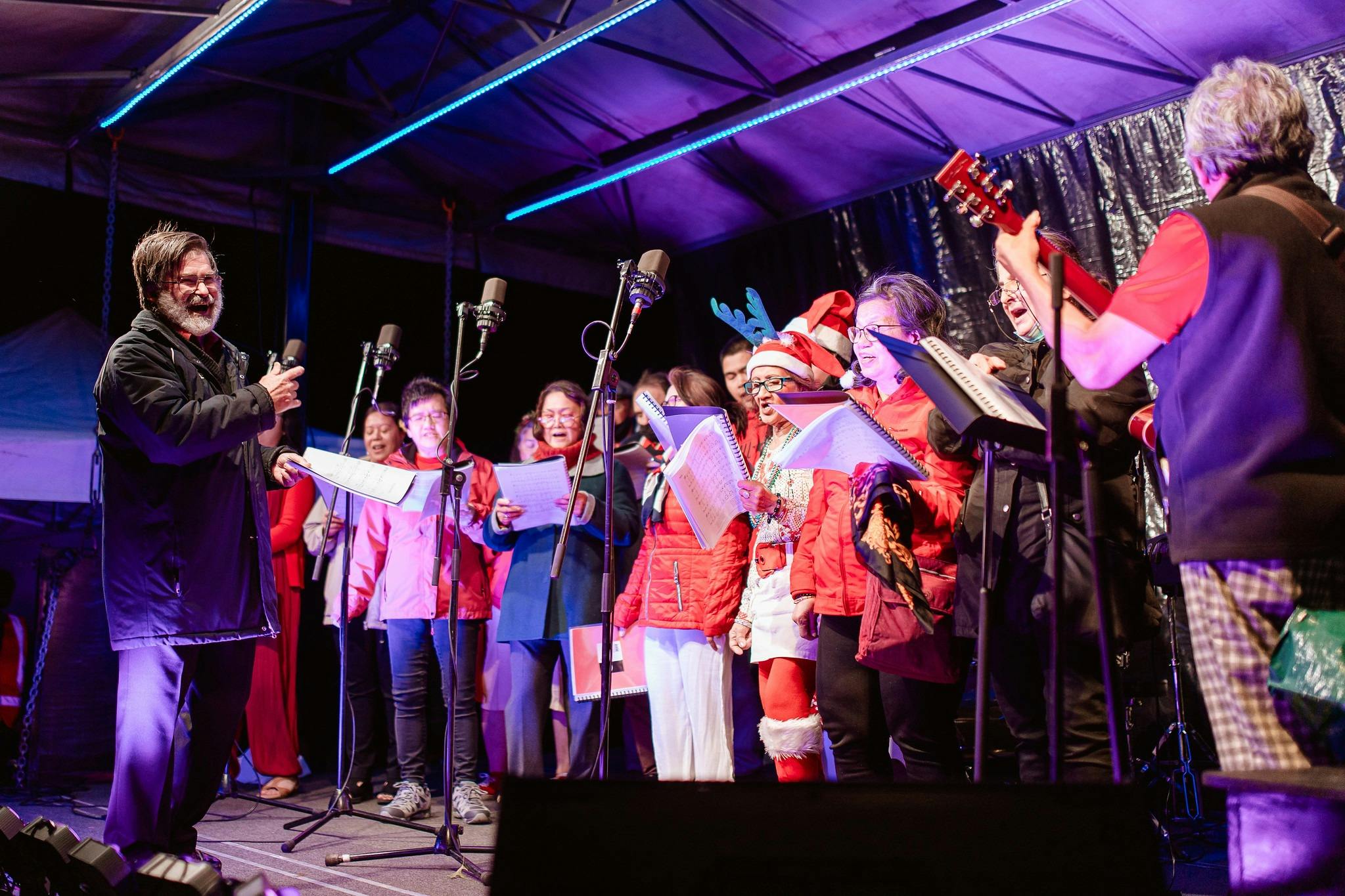 Carollers on stage in costume
