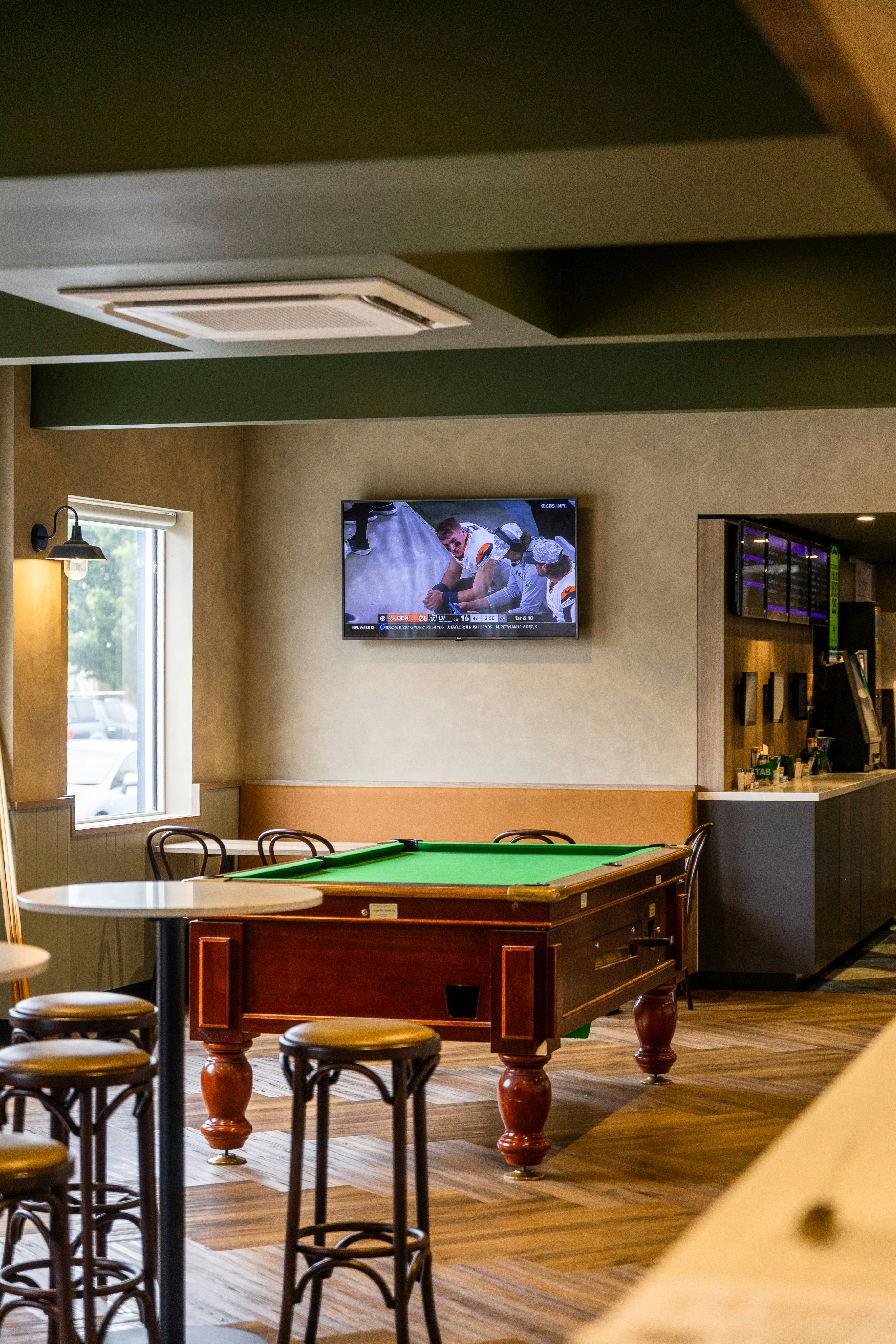 Public bar area with 8 ball table , sport on TVs and gaming